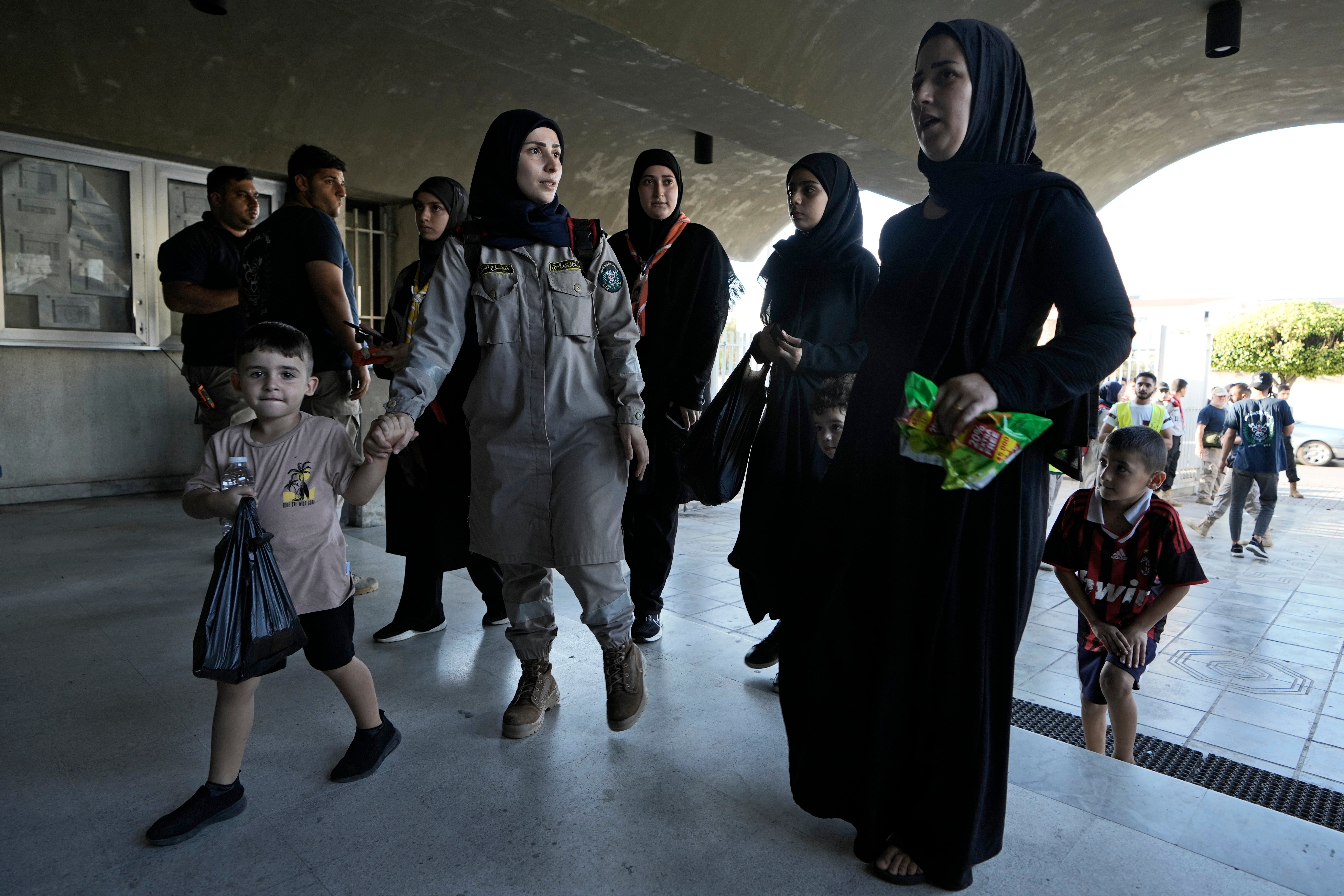 Women and children fleeing the Israeli airstrikes in the south, arrive at a school turned into a shelter in Beirut, Monday, 23 SeptEMBER 2024