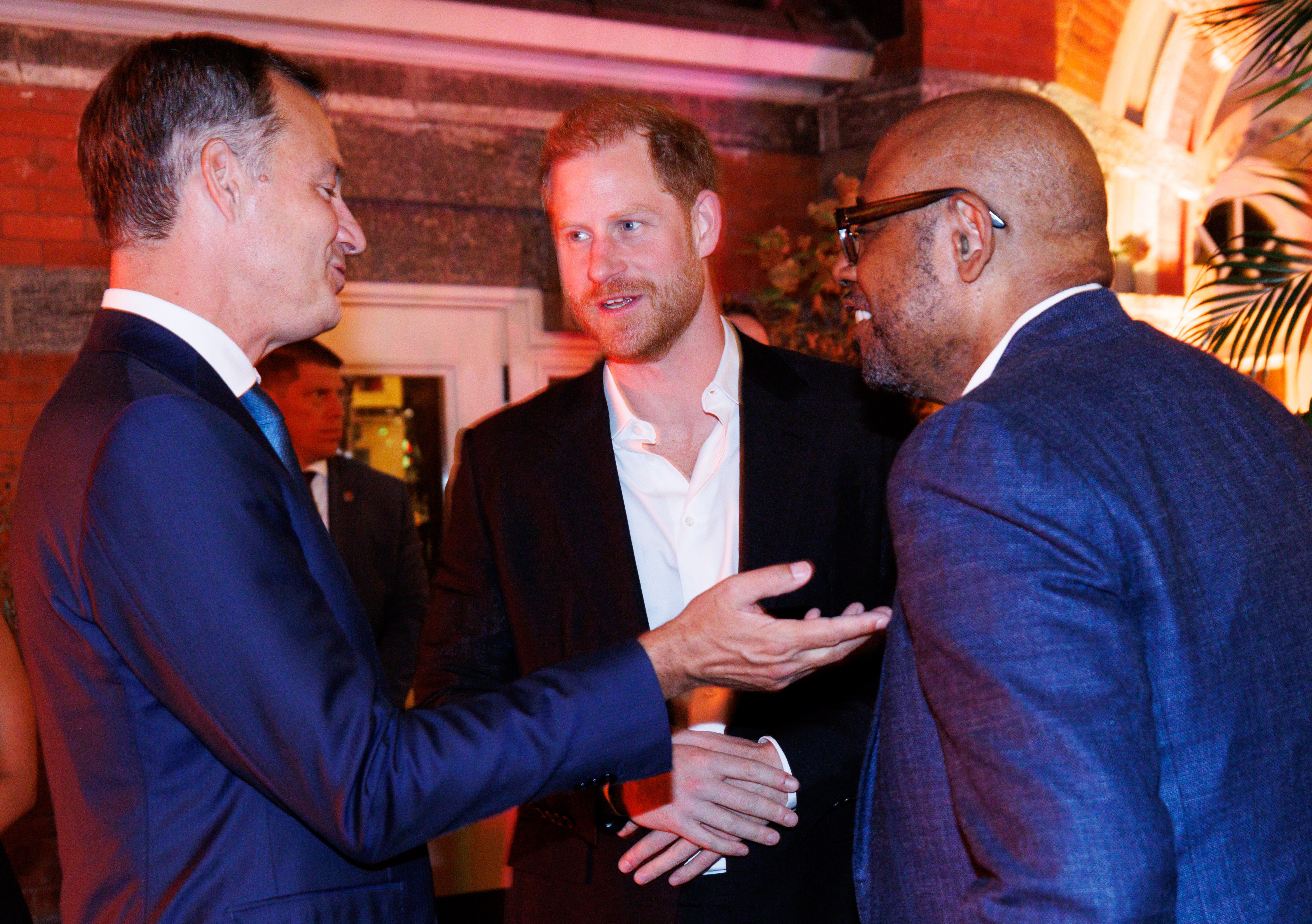 Harry, pictured with actor Forest Whitaker and outgoing Belgian prime minister Alexander de Croo, attended a WHO dinner alone