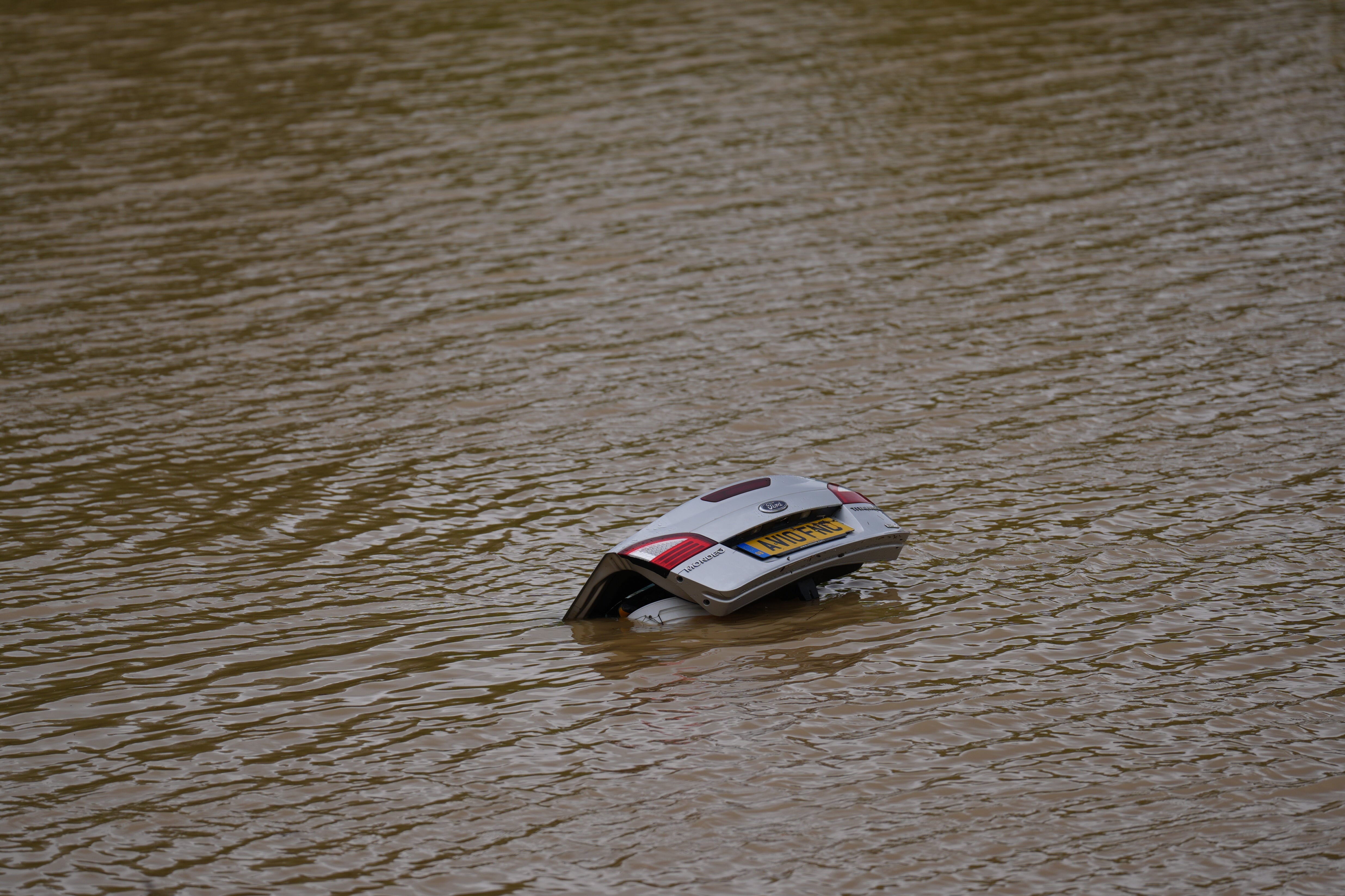 An overturned car in water on the A421 in Bedfordshire