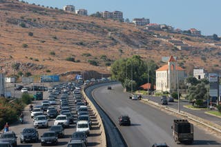 Vehicles wait in traffic in the town of Damour, south of the capital Beirut