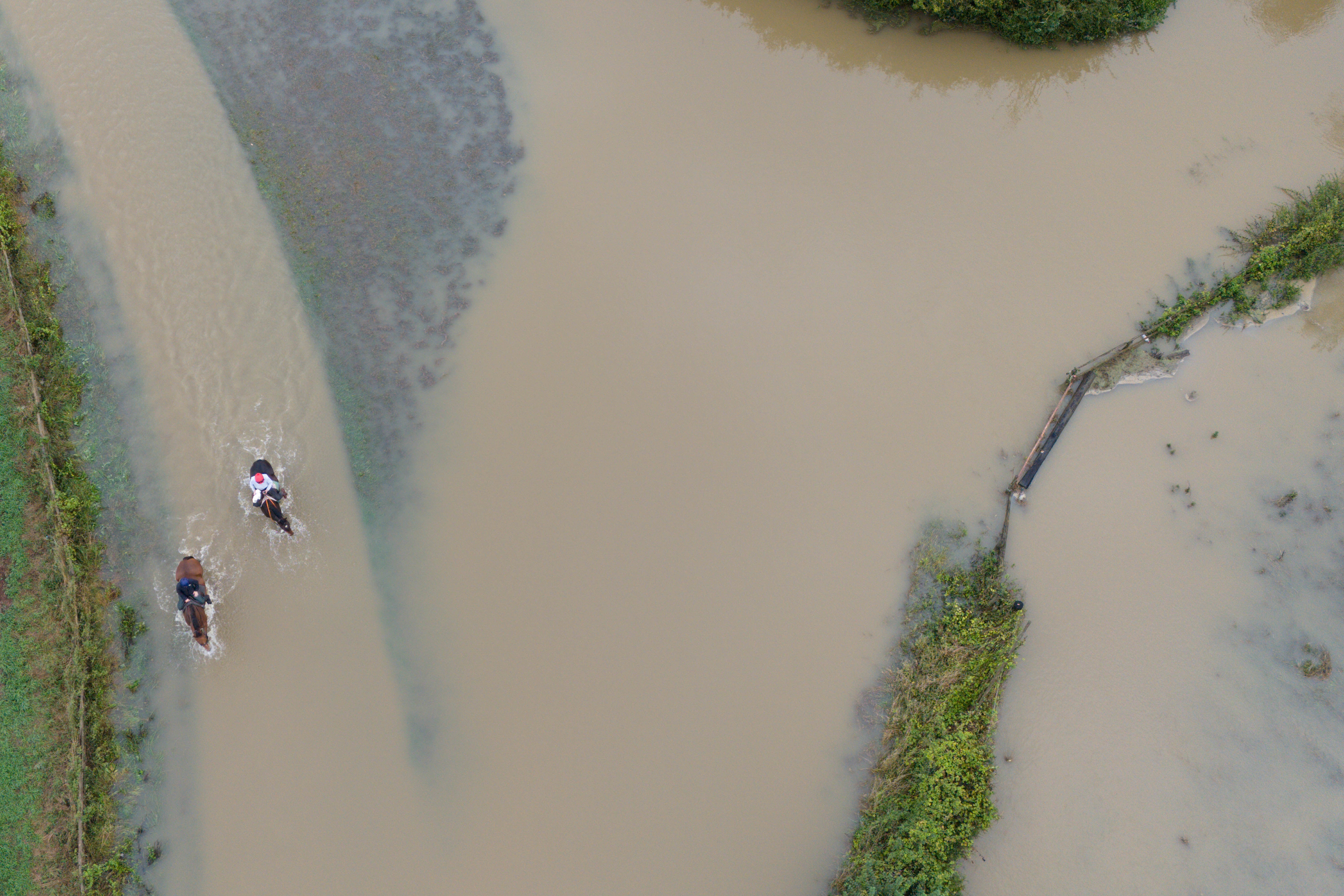 Horse riders make their way through floodwater in Walton in Warwickshire (Jacob King/PA)