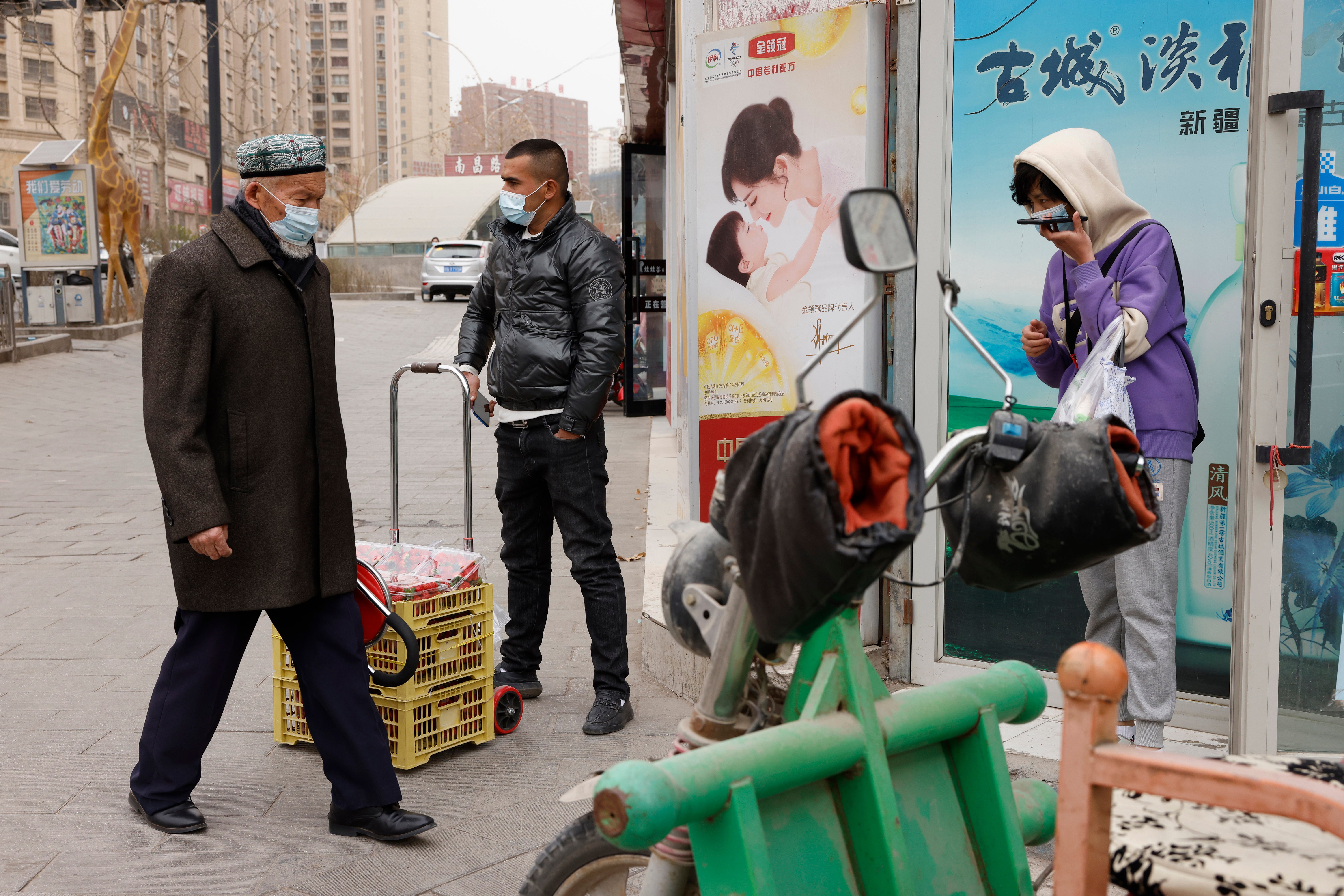 In this 18 March 2021 record  photo, residents wearing masks locomotion  on  the streets of Aksu successful  occidental  China's Xinjiang region