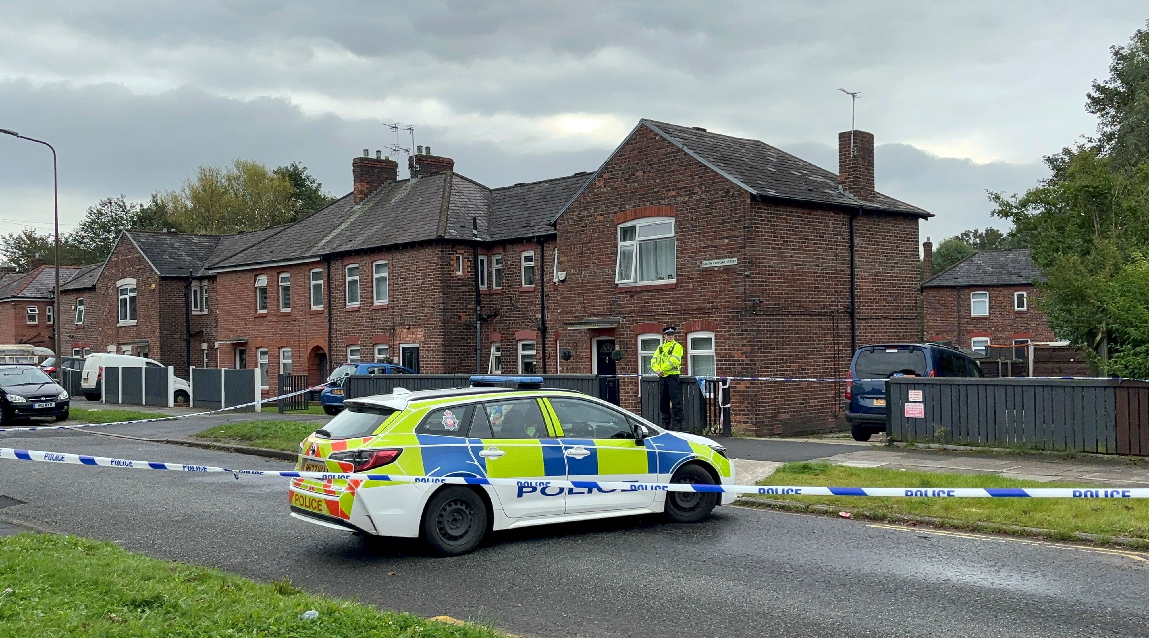 Police outside a house in Salford where the mother and child were found dead