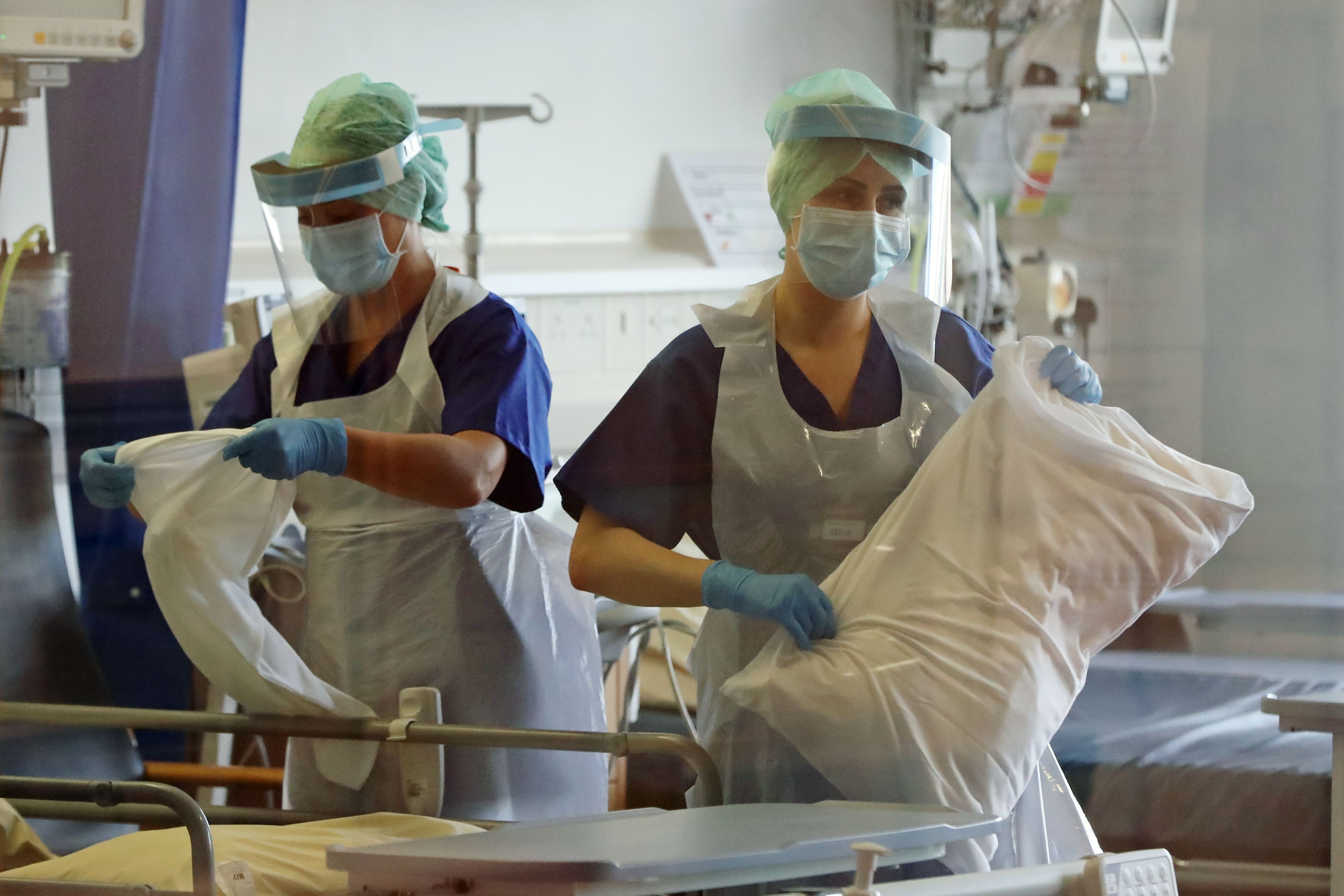 Nurses change bed clothes at the Mater Hospital Covid-19 recovery ward in Belfast (Niall Carson/PA)