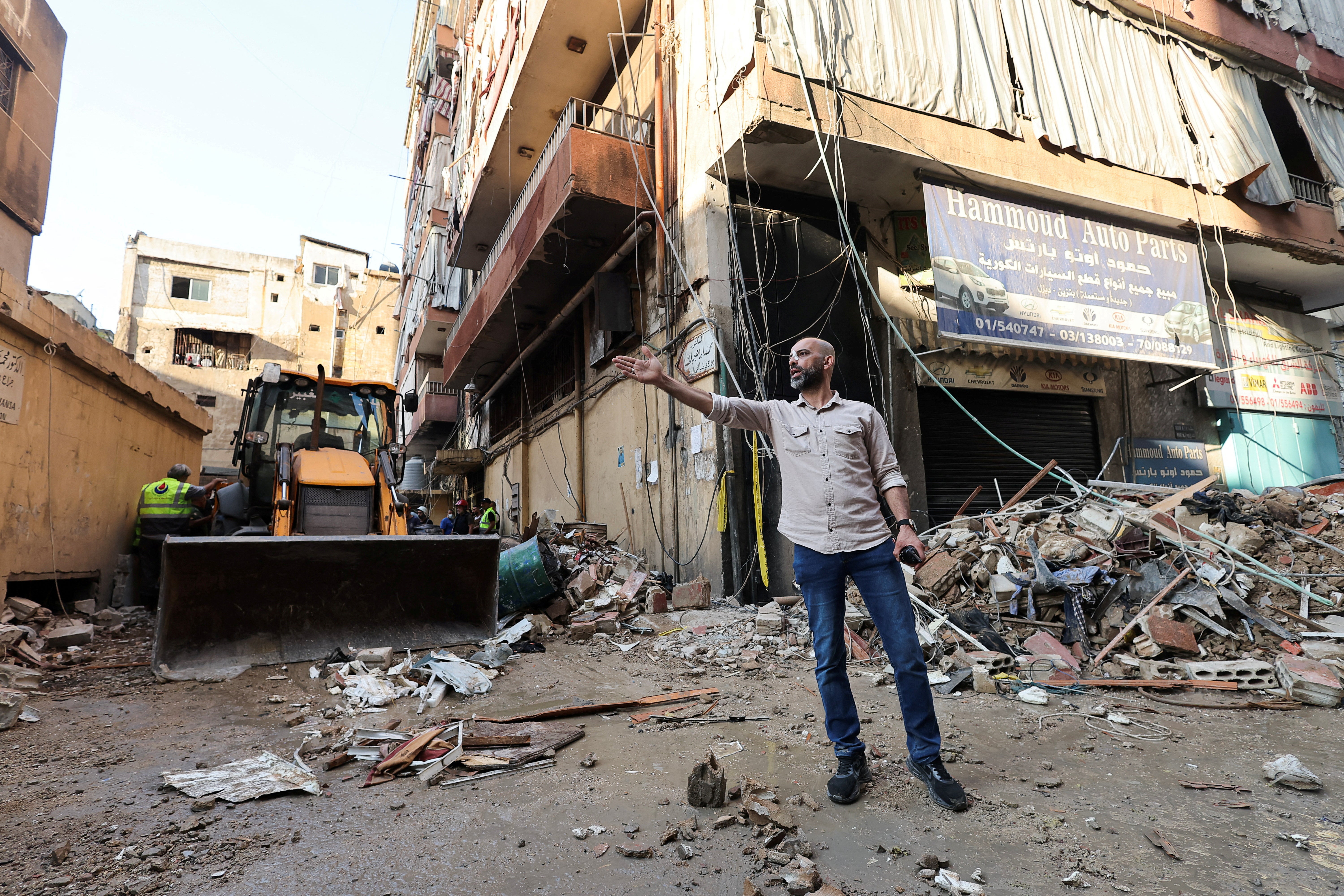 People gather at the site of an Israeli strike in Beirut's southern suburbs