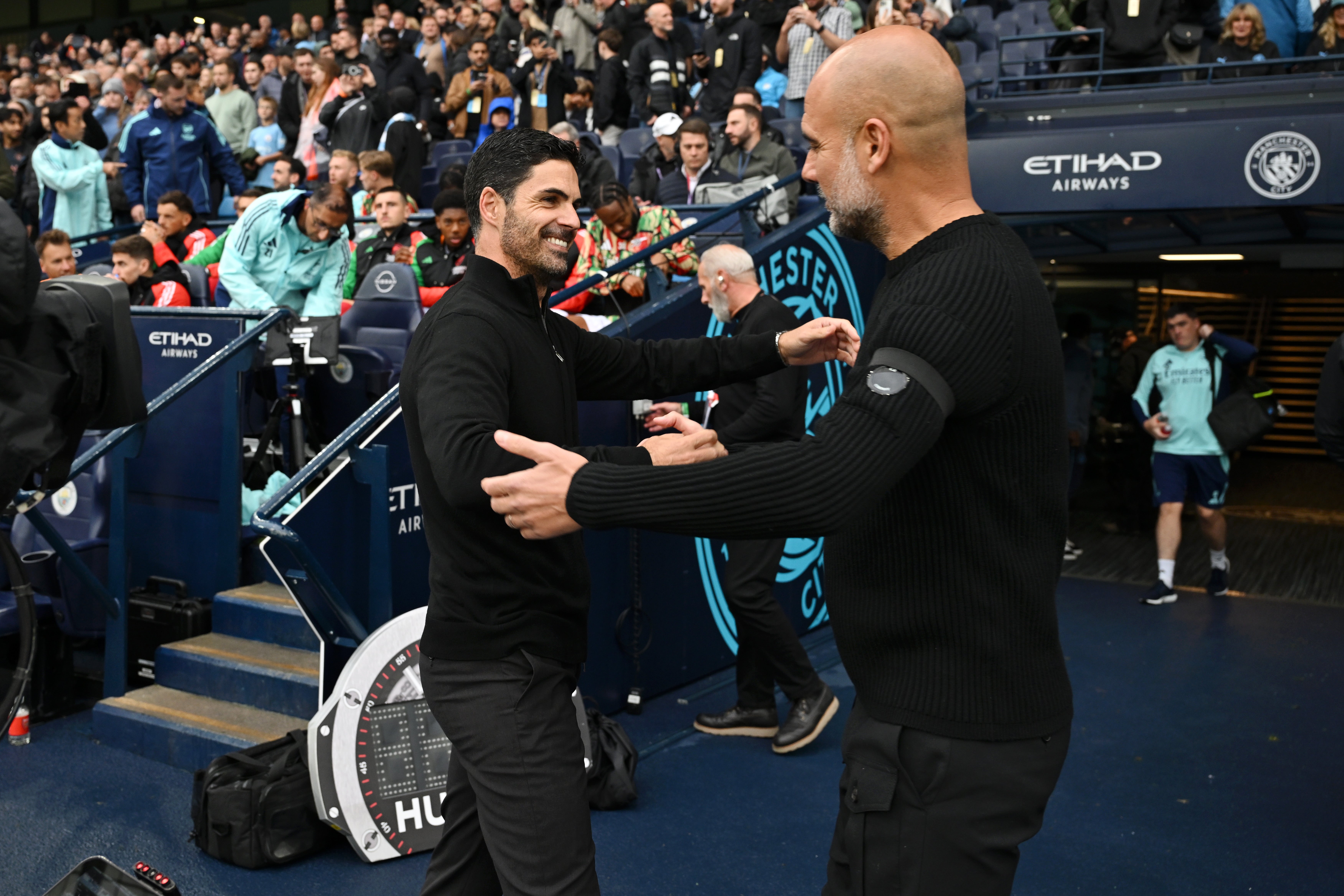 Pep Guardiola and Mikel Arteta embrace at the Etihad