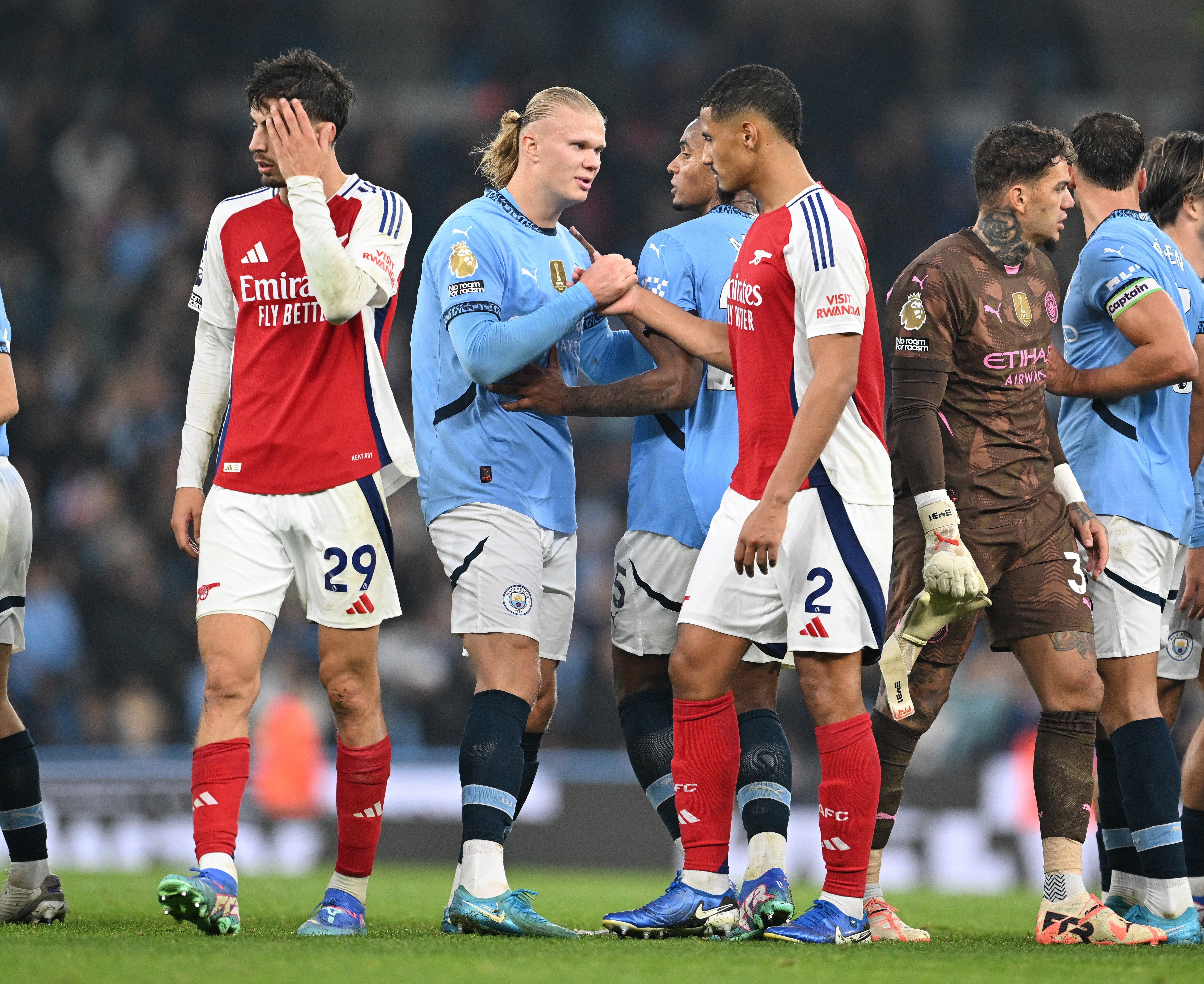 William Saliba of Arsenal shakes hands with Erlimng Haaland of Man City