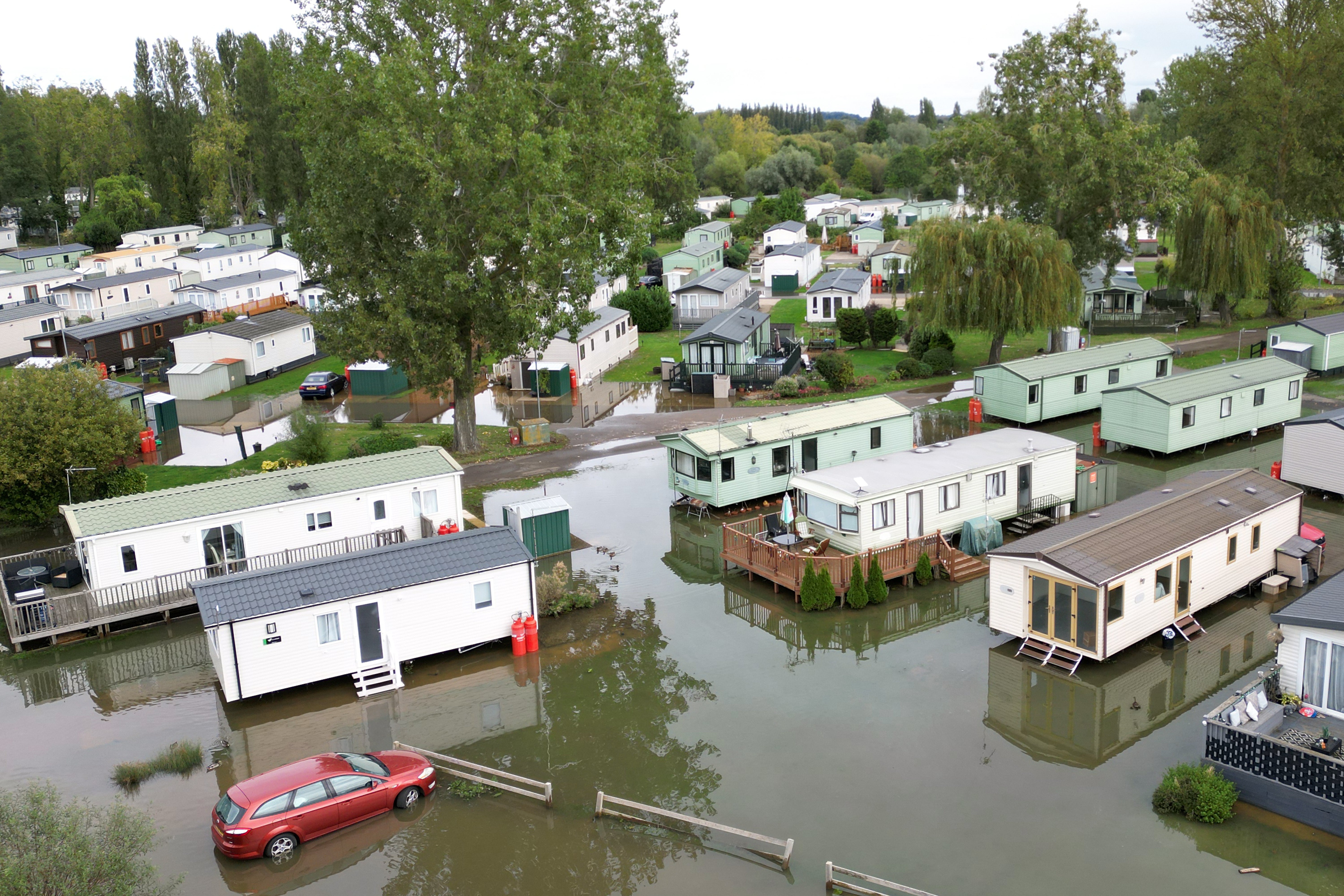 A car sits in floodwater at the Billing Aquadrome holiday park, Northamptonshire, where firefighters and police worked until late on Tuesday night as flooding forced 43 residents to evacuate