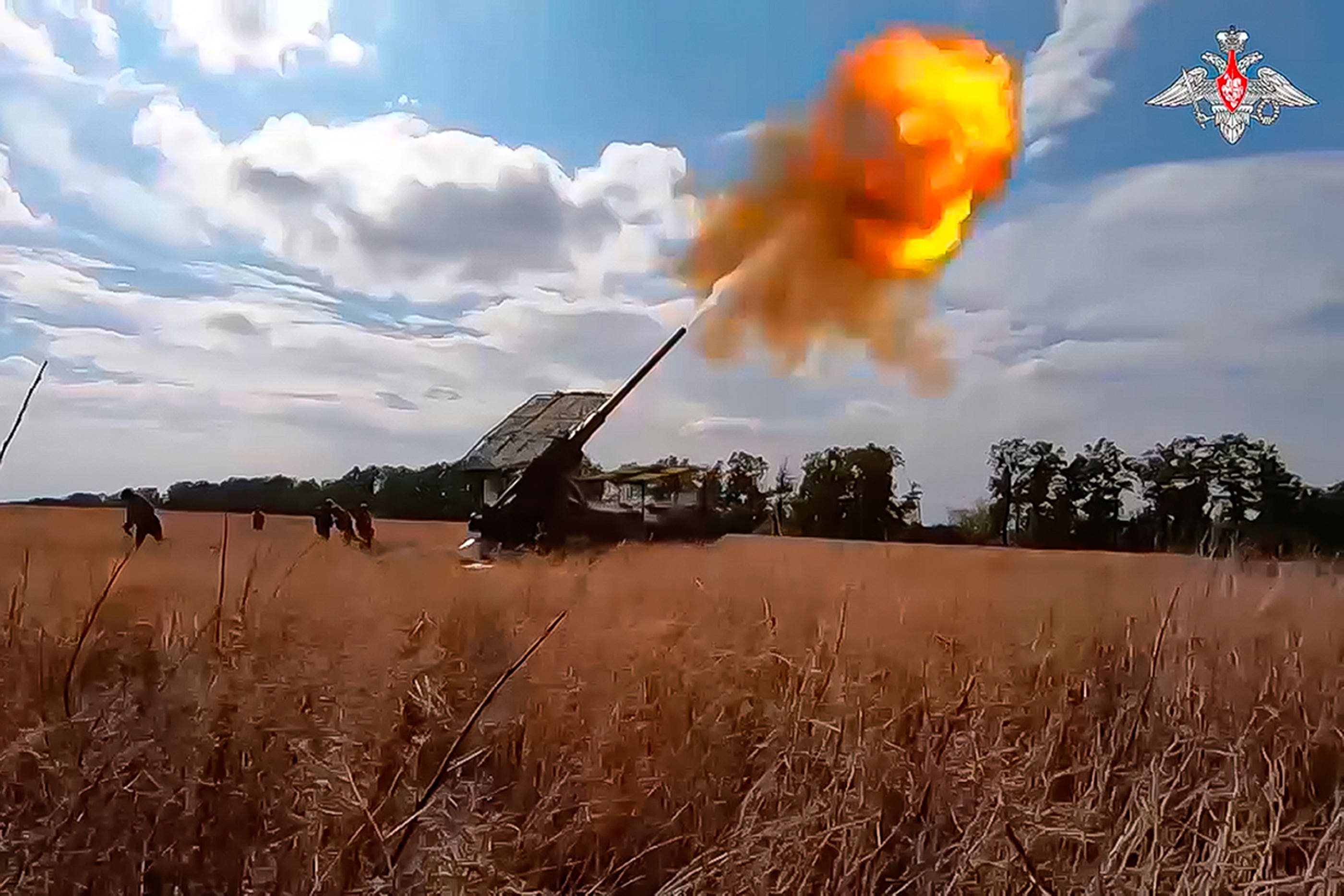 Russian soldiers fire a Pion self-propelled cannon towards Ukrainian positions at an undisclosed location