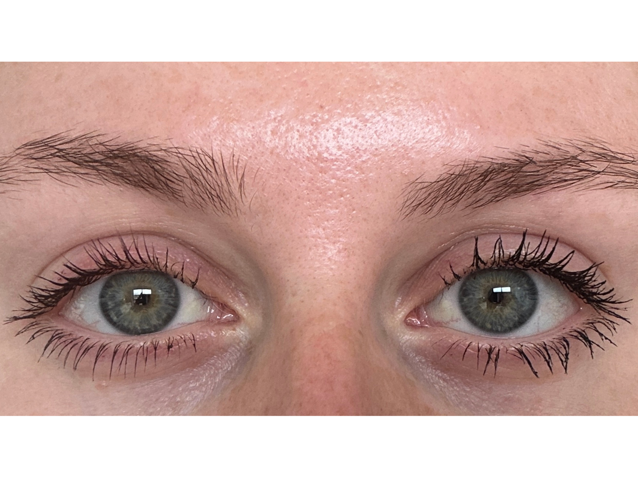 The burgundy mascara worn on the left versus black on the right