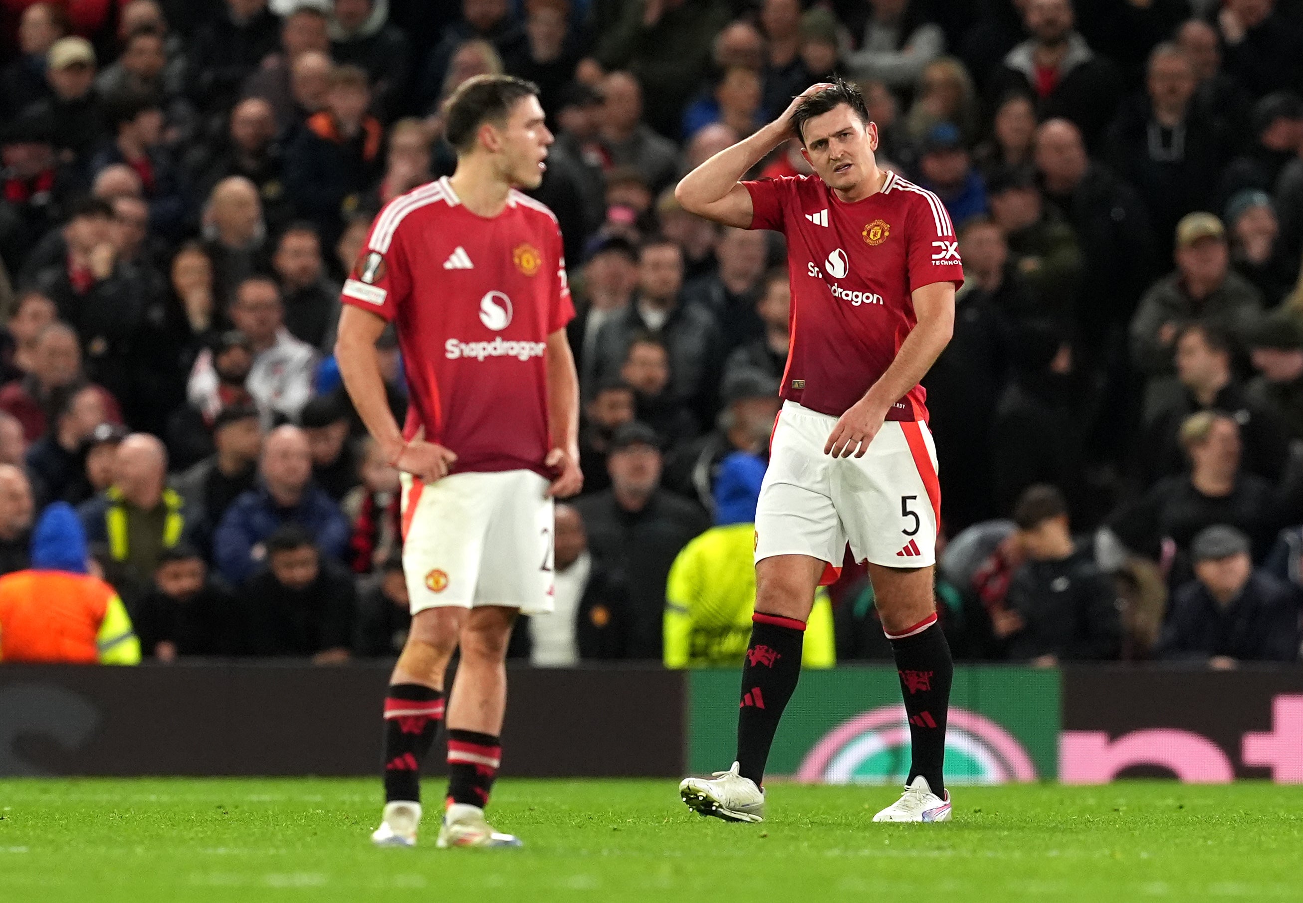 Harry Maguire, right, look frustrated after Twente’s Sam Lammers equalises (Martin Rickett/PA)