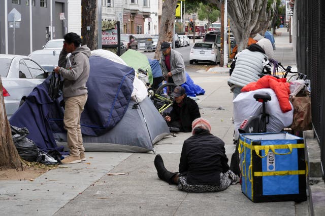 <p>Homeless people gather with their belongings and tents in the Mission District in September 2024. Homelessness has become a problem across California</p>