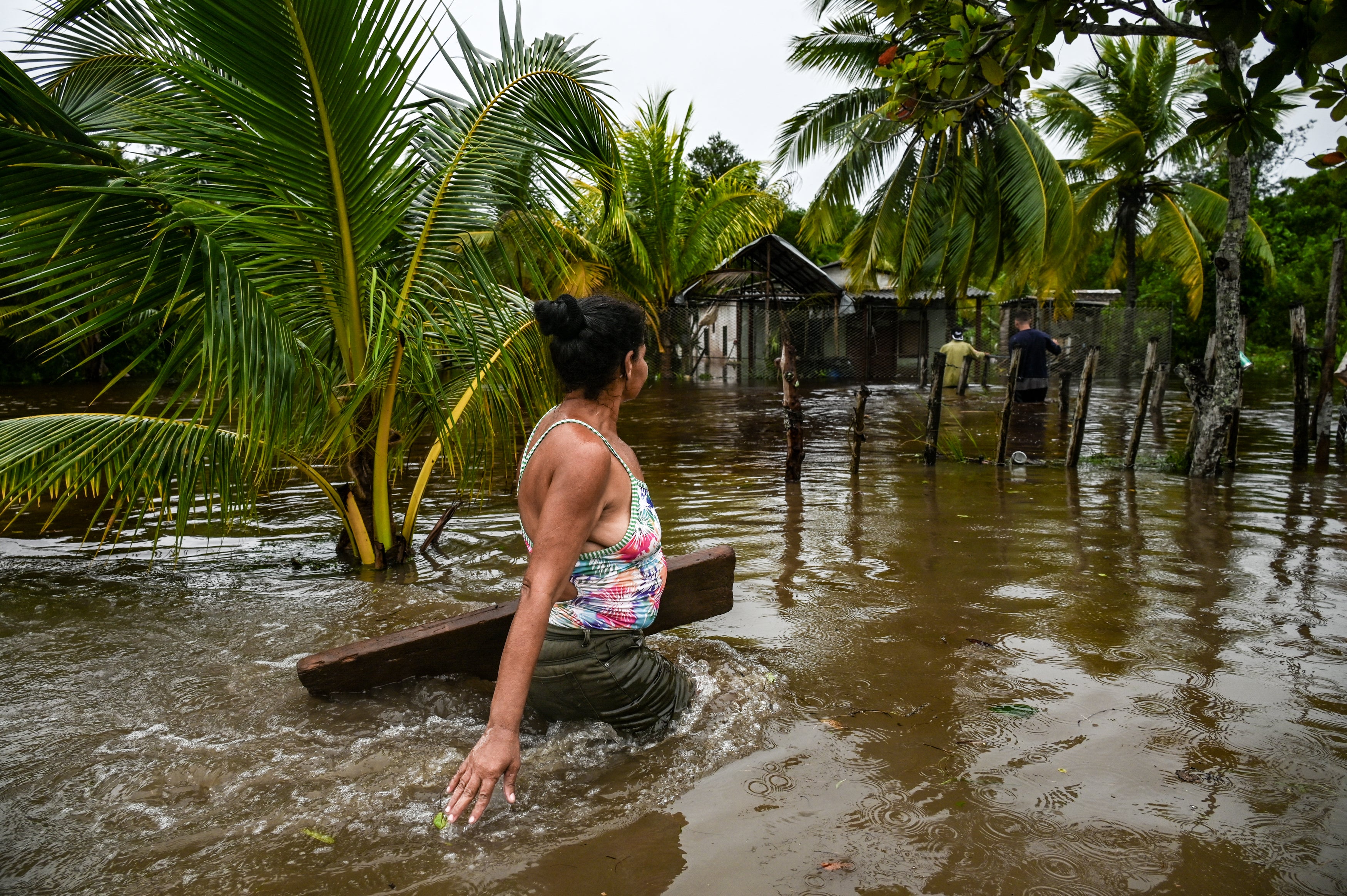 A woman walks through a flooded street after Hurricane Helene passed through Guanimar, Cuba