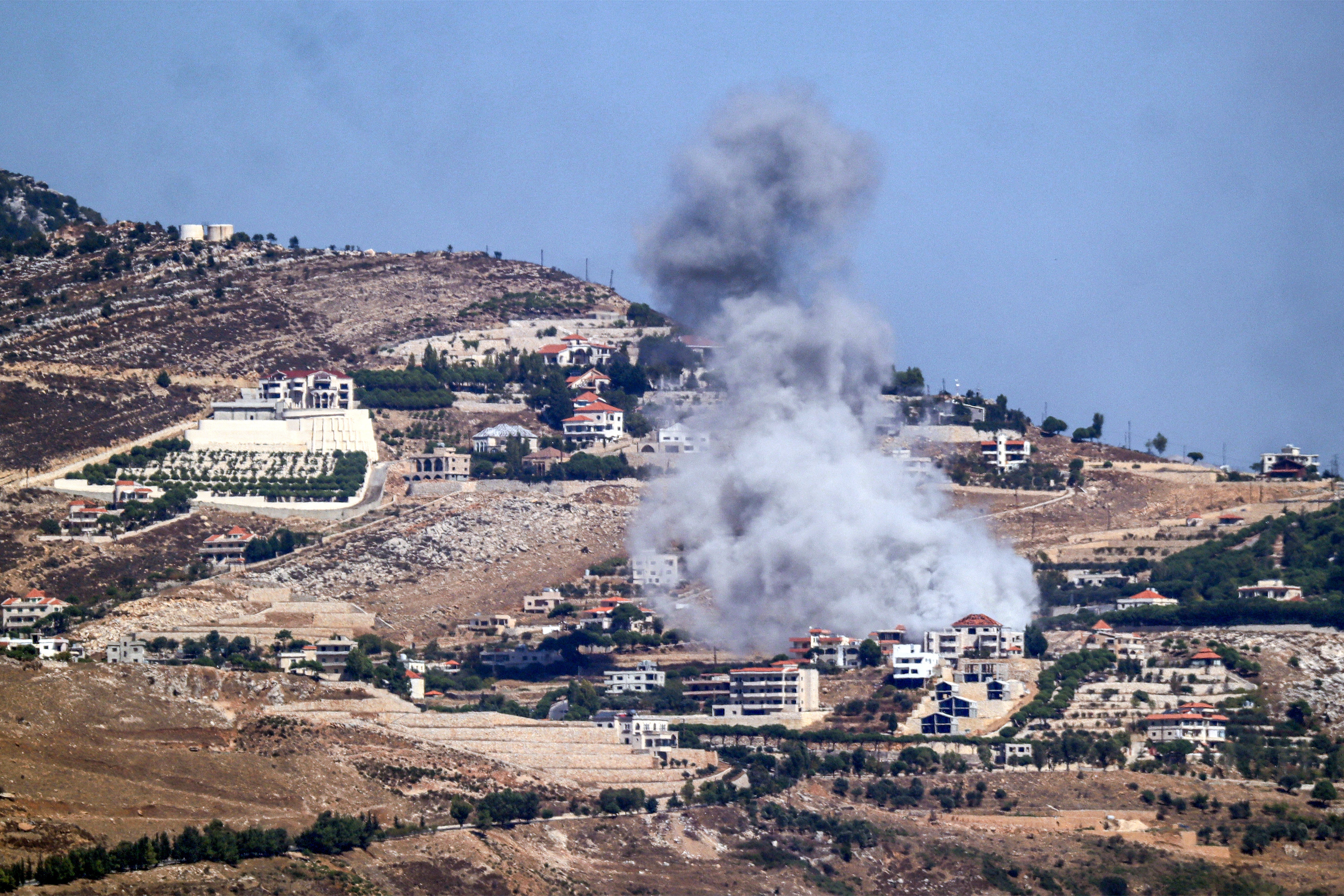 A cloud of smoke erupts during an Israeli air strike on the village of Sujud in southern Lebanon on September 25, 2024