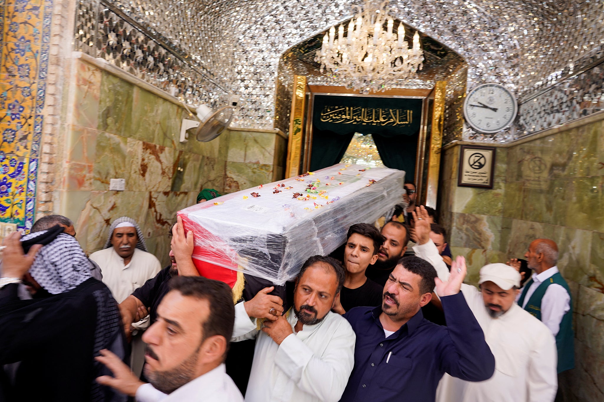 Mourners carry the coffin of an Iraqi killed in Lebanon