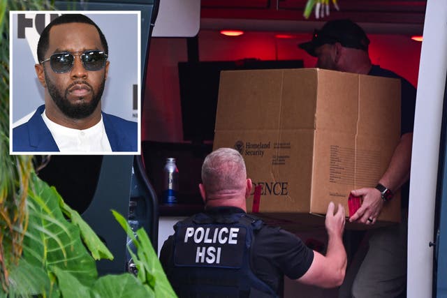 <p>Homeland Security Investigation agents load a box into a car at the entrance of Diddy’s Miami home</p>