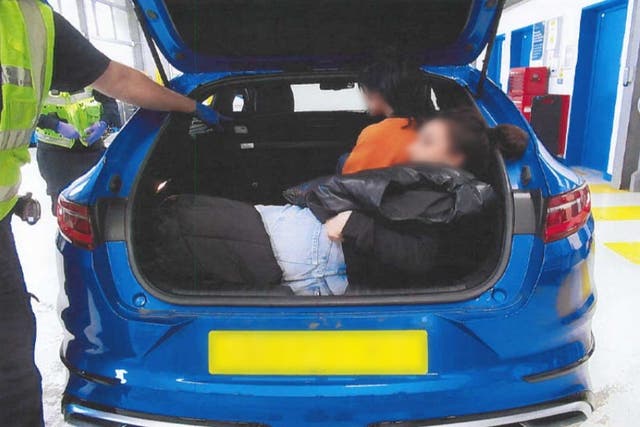 Blurred at source. Two migrants were crammed in the back of a car bound for the UK (Home Office/PA)