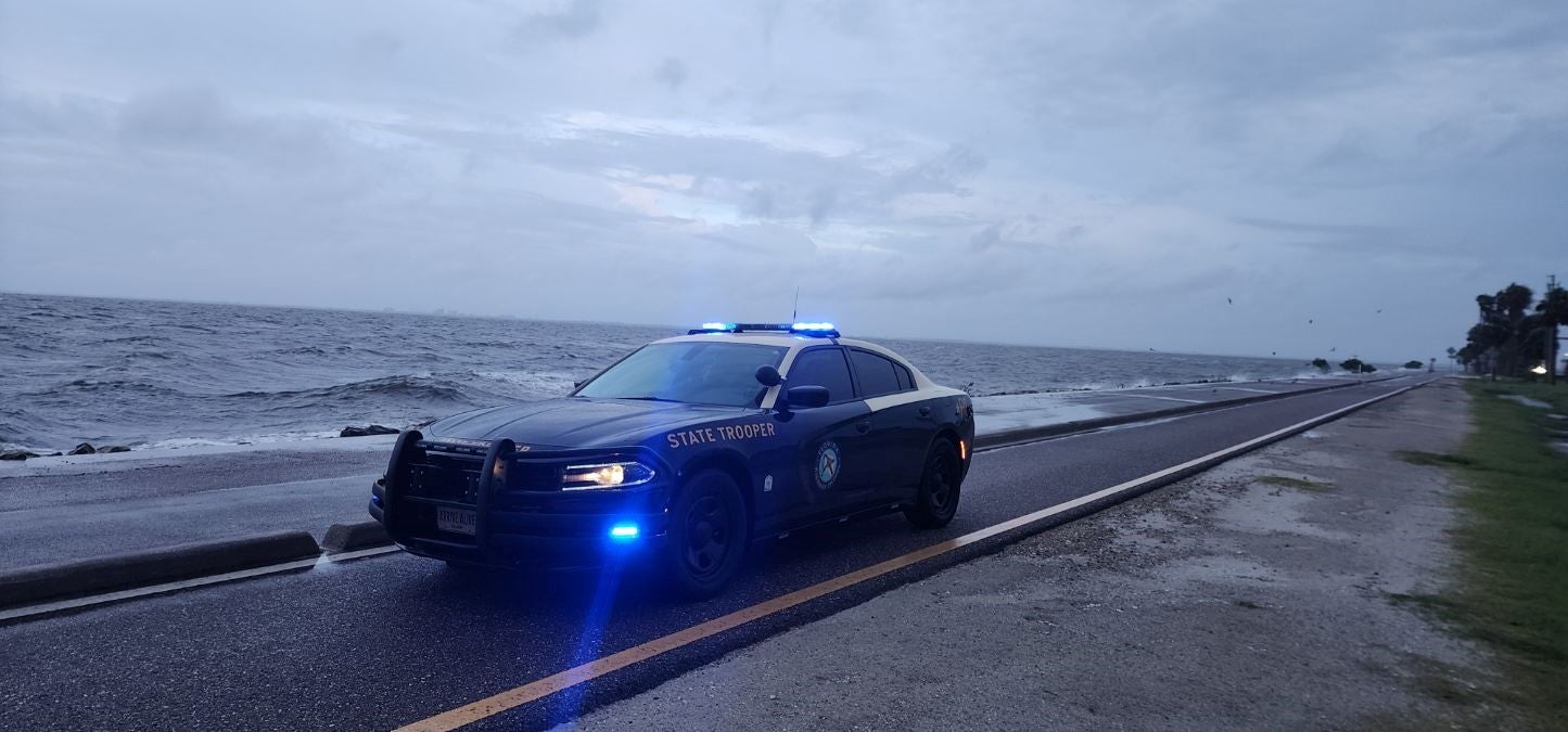 A state trooper sits at the Sunshine Skyway Bridge as weather conditions there deteriorate