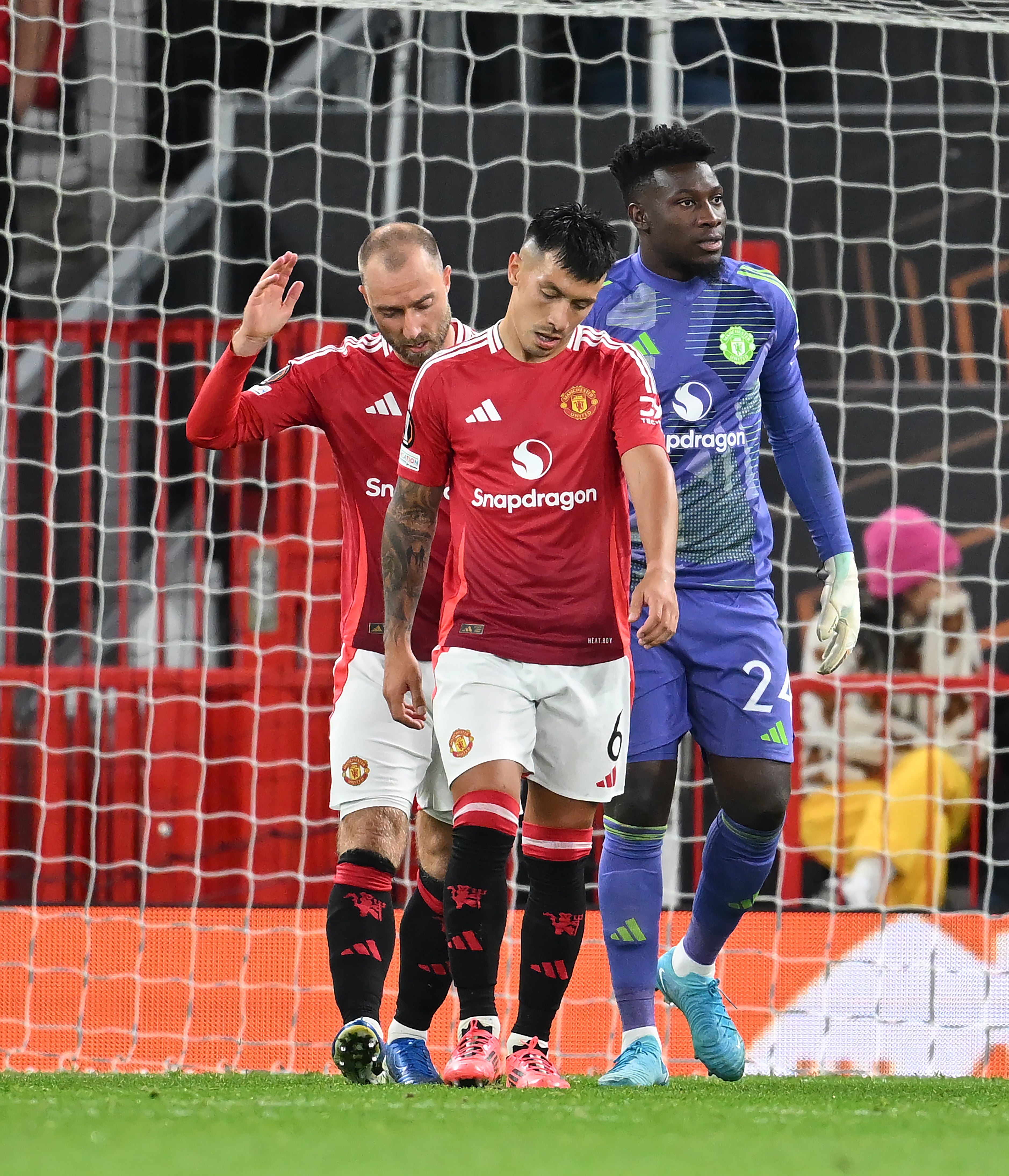 Christian Eriksen, Lisandro Martinez and Andre Onana of Manchester United look dejected