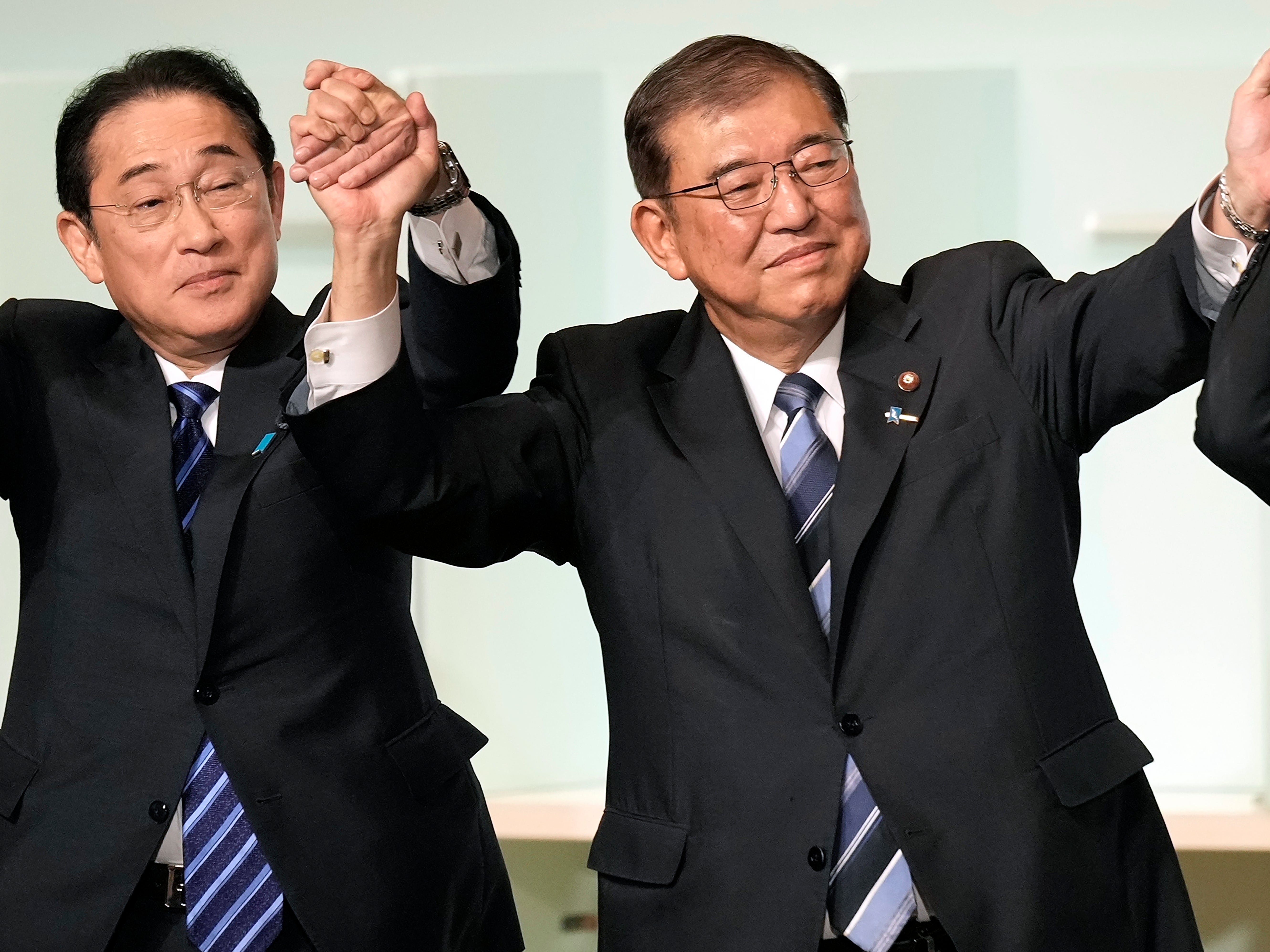 Shigeru Ishiba, right, with Japan’s current prime minister Fumio Kishida, left, and other candidates, celebrates after Ishiba was elected as new head of Japan’s ruling Liberal Democratic Party during its leadership election Friday, 27 September 2024 in Tokyo