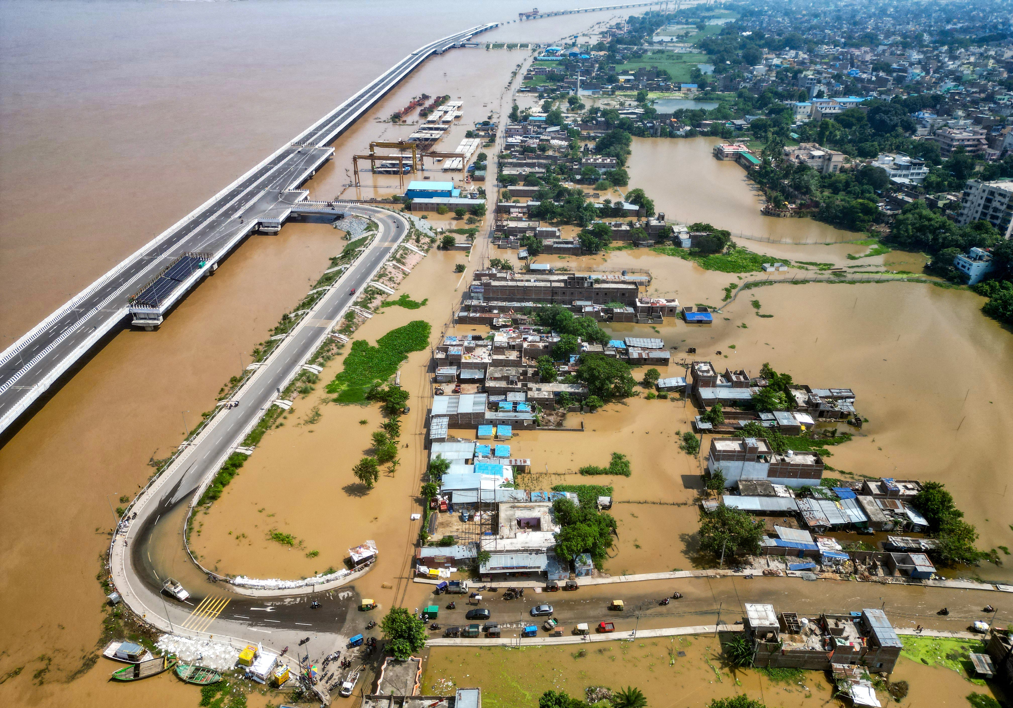 An aerial view shows houses partially submerged by flooding in the Ganges river in Patna, Bihar, on 20 September 2024