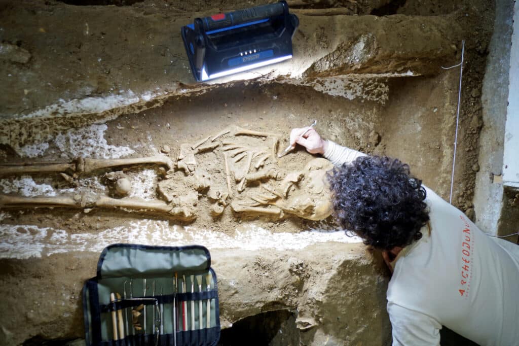 A burial is excavated with special tools