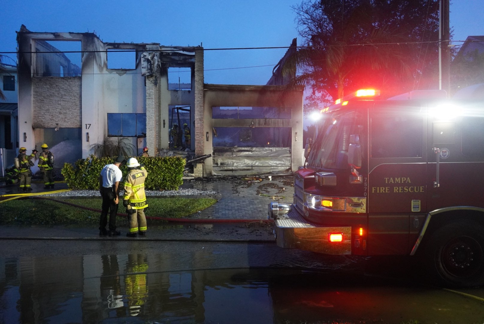 Tampa Fire Rescue looks at a residential structure burned in a fire early Friday