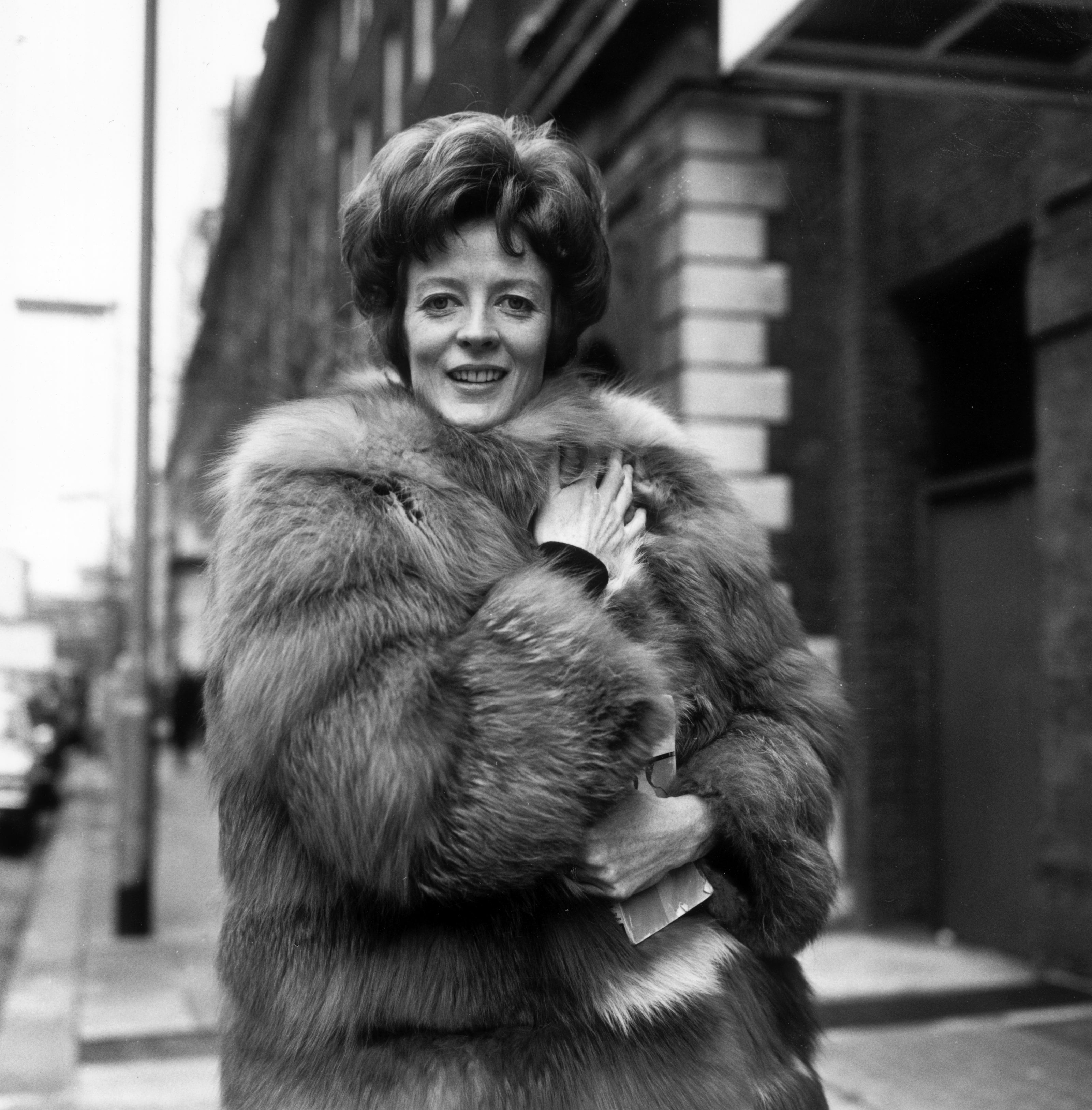 Dame Maggie wears a fur coat as she poses for a portrait in January 1969