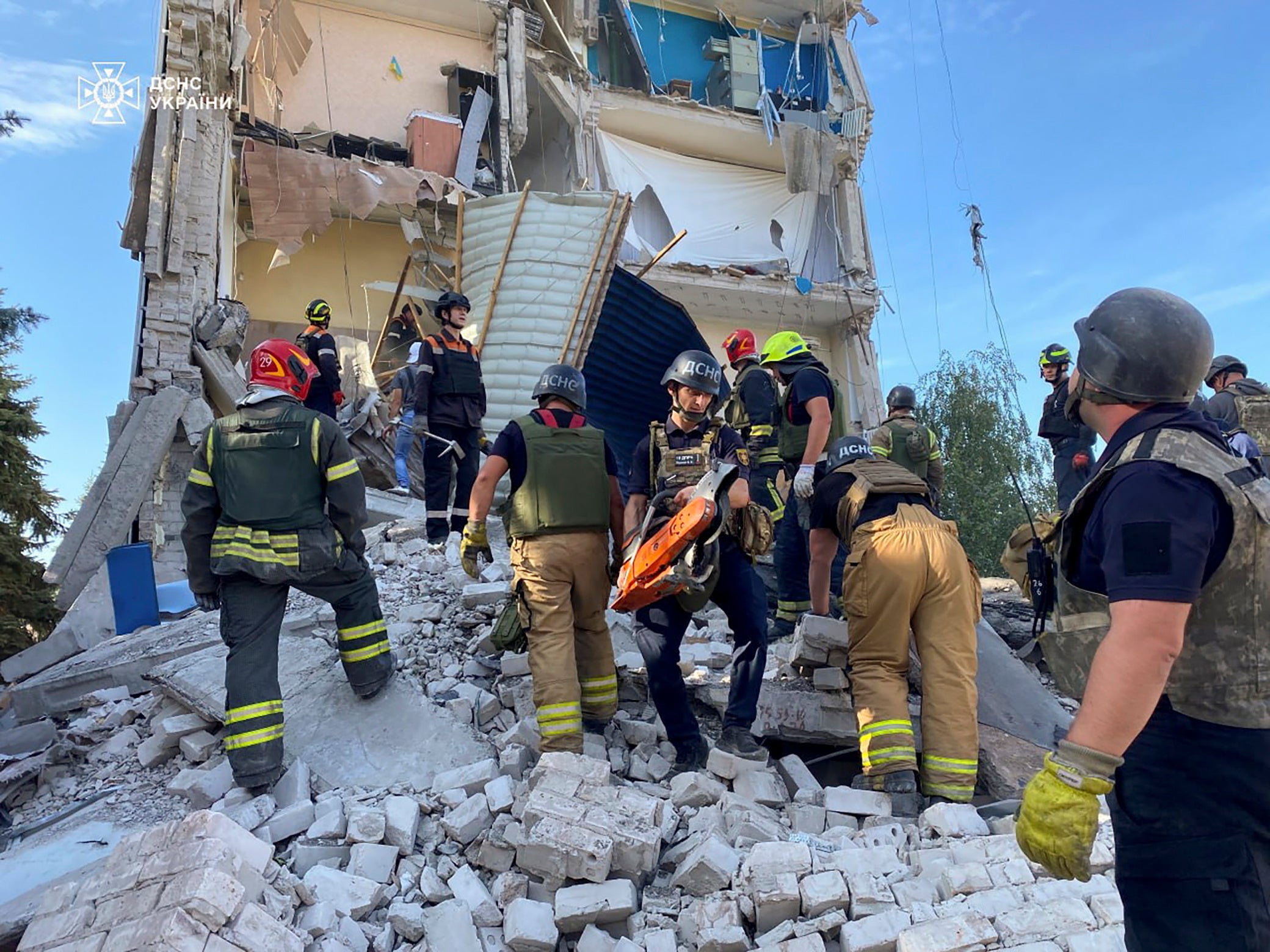 A handout photo made available by the State Emergency Service shows Ukrainian rescuers work at the site of National Police headquarters following a shelling in Kryvyi Rih