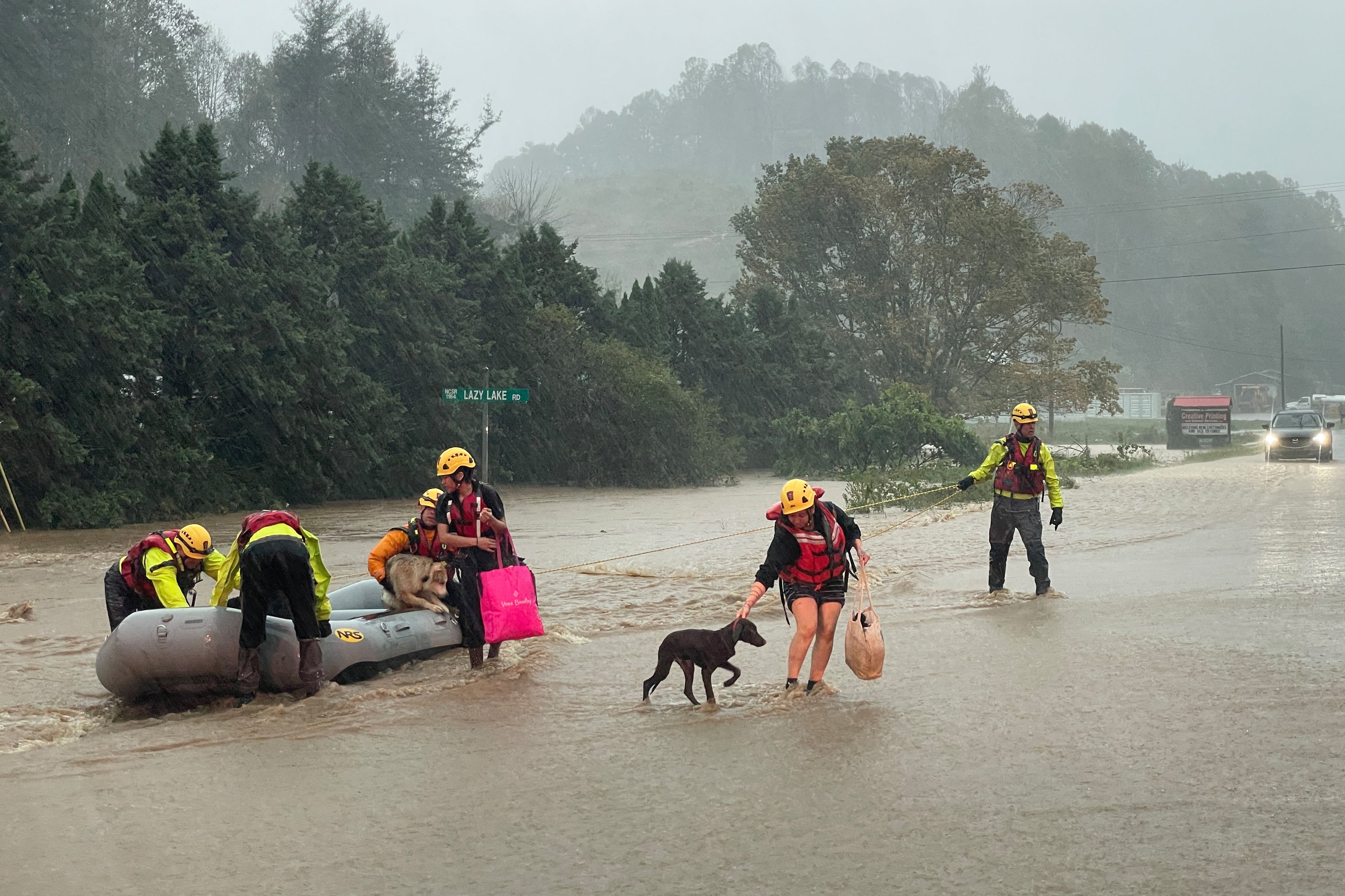 Residents lead their pets to safety on Friday in Boone, North Carolina