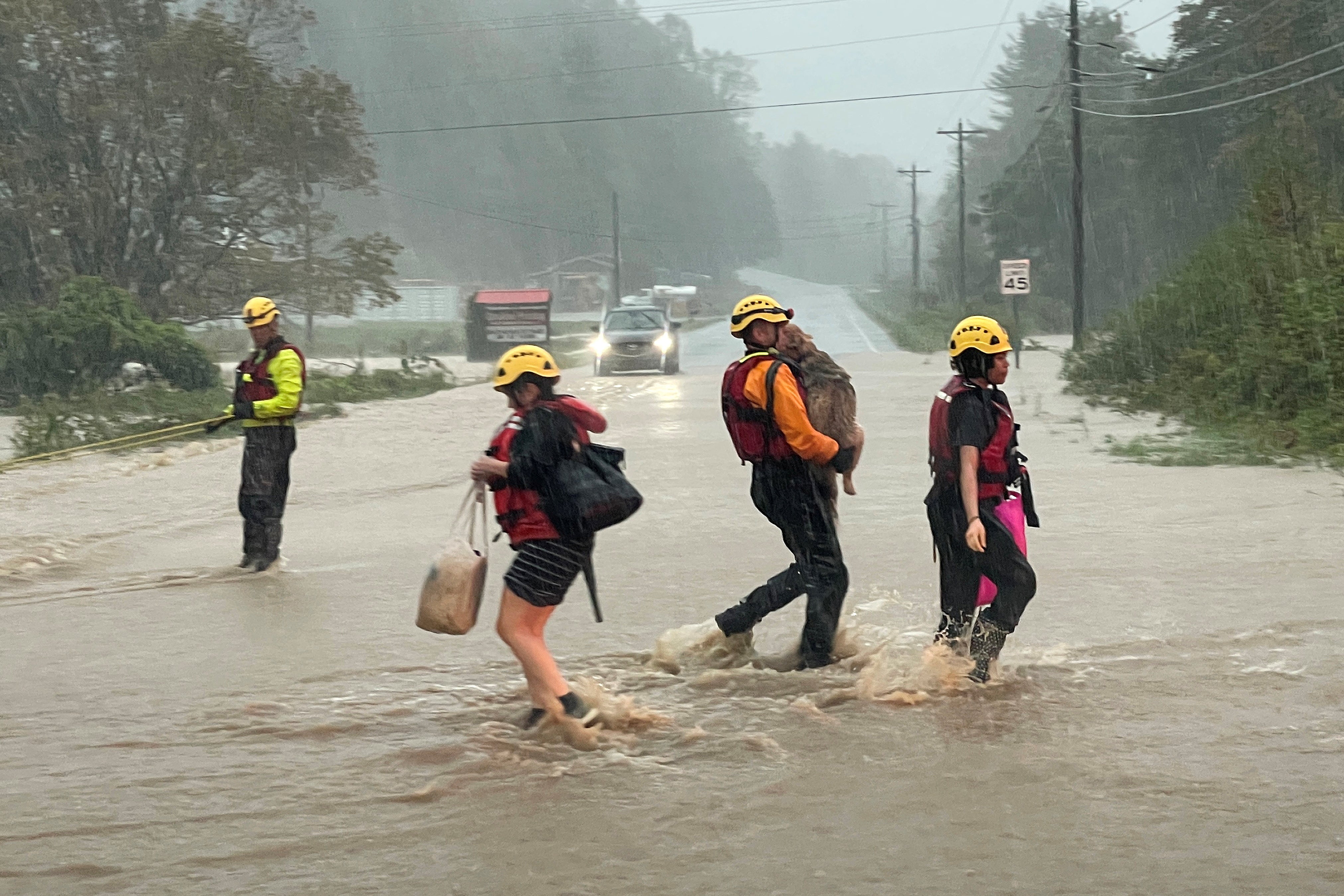 A swift water rescue worker carries a pet dog on Friday in Boone, North Carolina