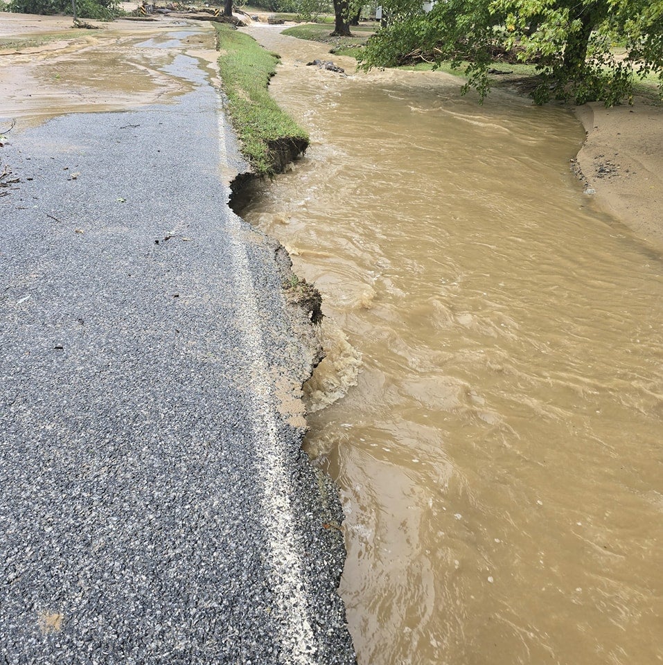 Flooding and a badly-damaged road near Bat Cave around Lake Lure, North Carolina on Friday following impacts from storm Helene