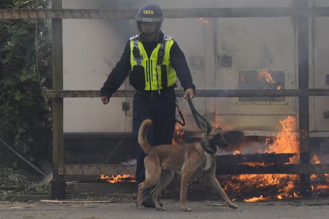 A police dog handler during an anti-immigration demonstration outside the Holiday Inn Express in Rotherham in August (Danny Lawson/PA)