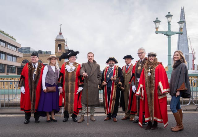 <p>Damien Lewis (centre) poses with Freeman of the City and the Lord Mayor of London, Michael Mainelli (left of Lewis) ahead of driving sheep over Southwark Bridge, London (James Manning/PA)</p>