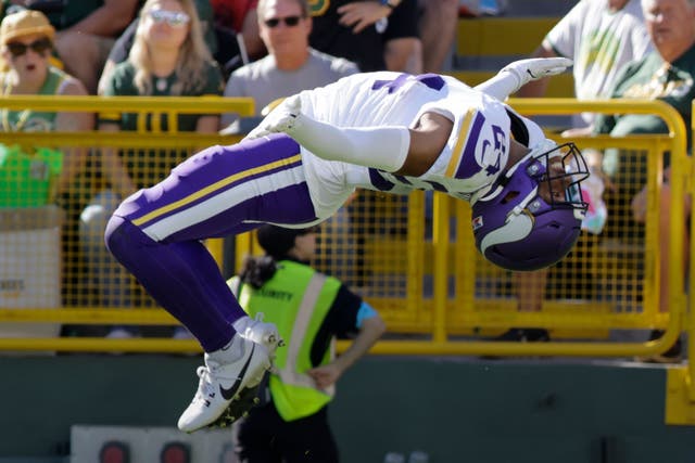 Minnesota Vikings safety Camryn Bynum does a backflip as he celebrates a fumble recovery (Mike Roemer/AP)