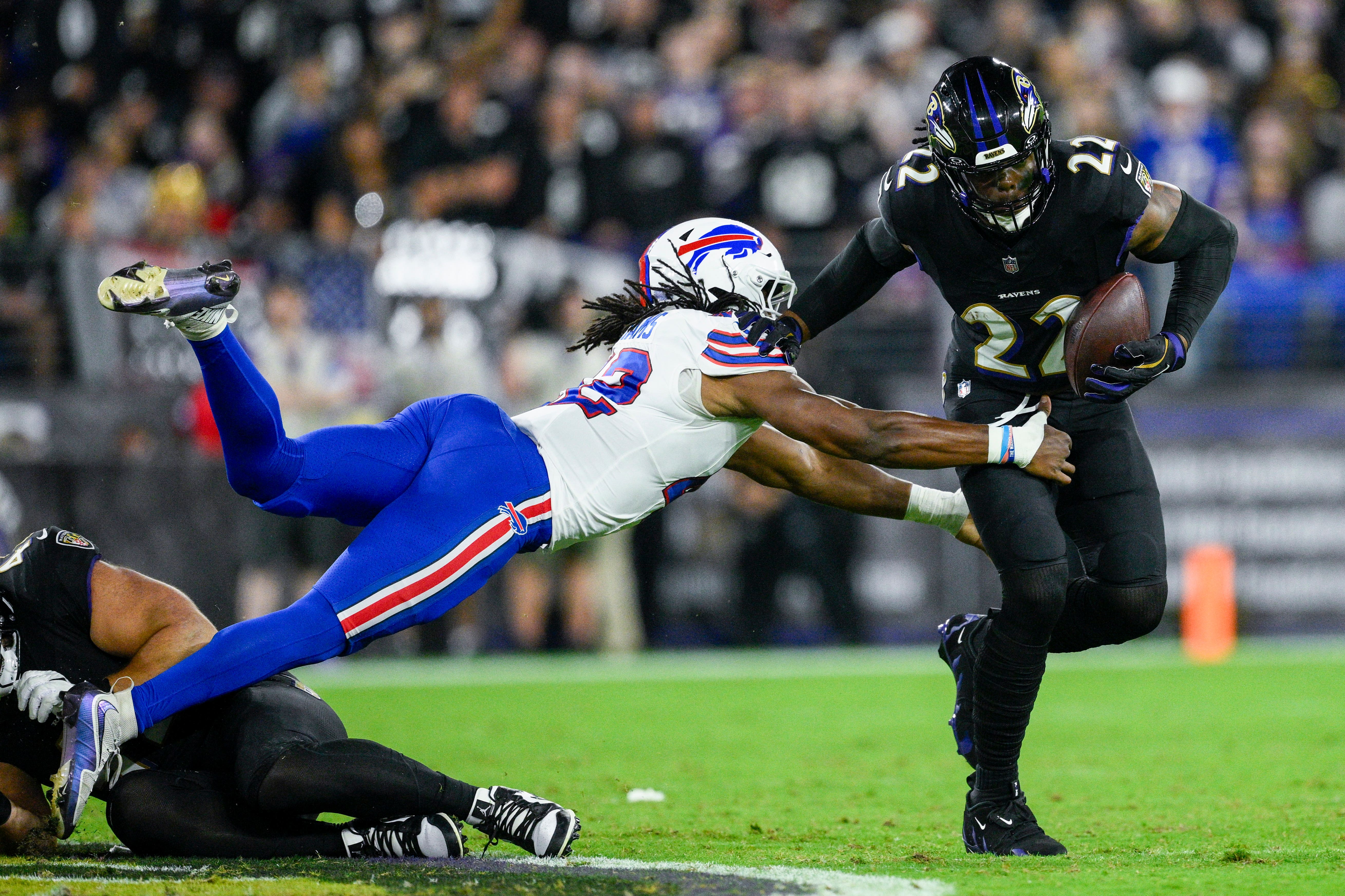 Baltimore Ravens running back Derrick Henry, right, runs with the ball as Buffalo Bills linebacker Dorian Williams tries to stop him (Nick Wass/AP)