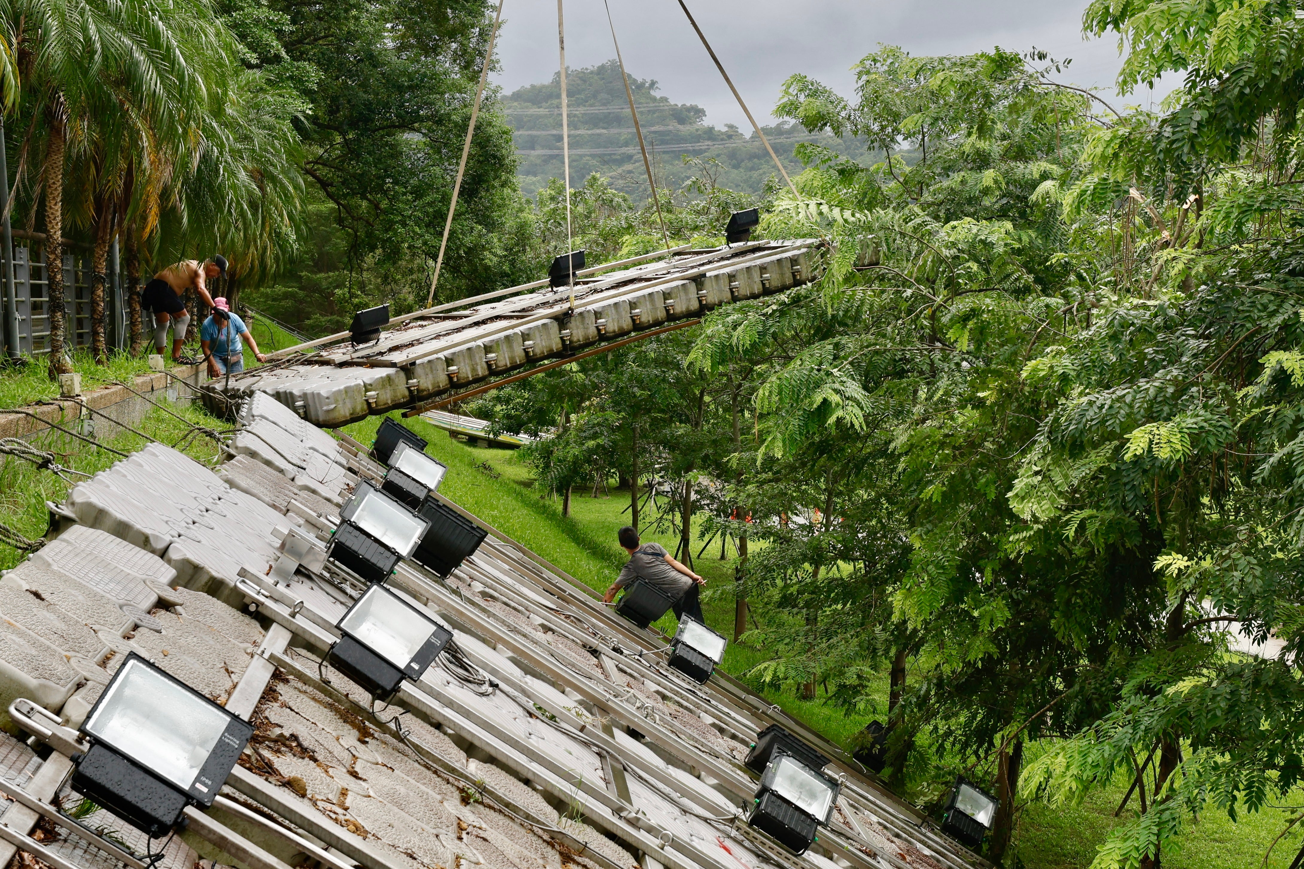 Taiwanese workers secure platforms in anticipation for Typhoon Krathon at the riverside in New Taipei City, Taiwan