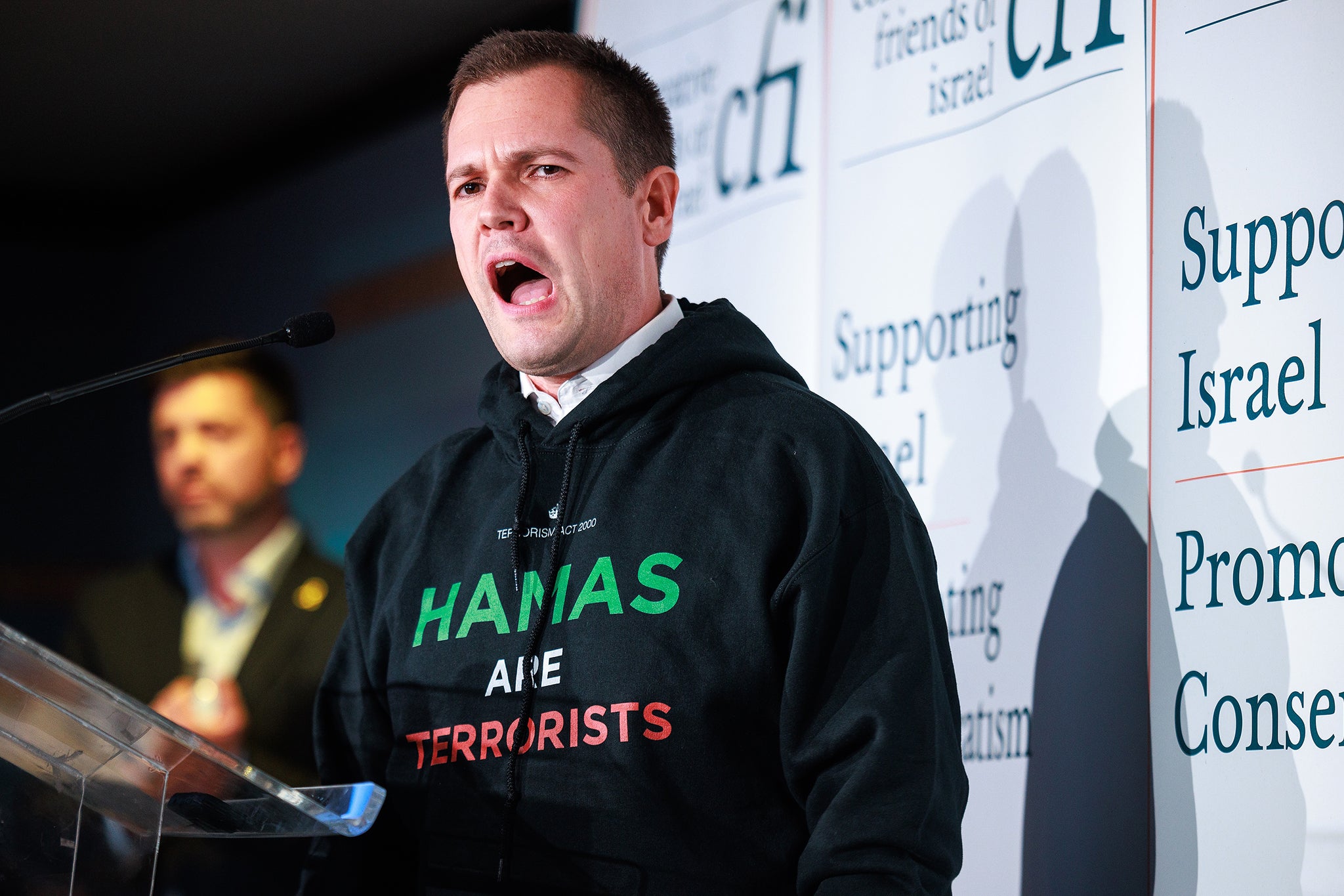 Robert Jenrick wearing a “Hamas are terrorists” hoodie as he speaks at a Conservative Friends of Israel fringe event in the conference venue