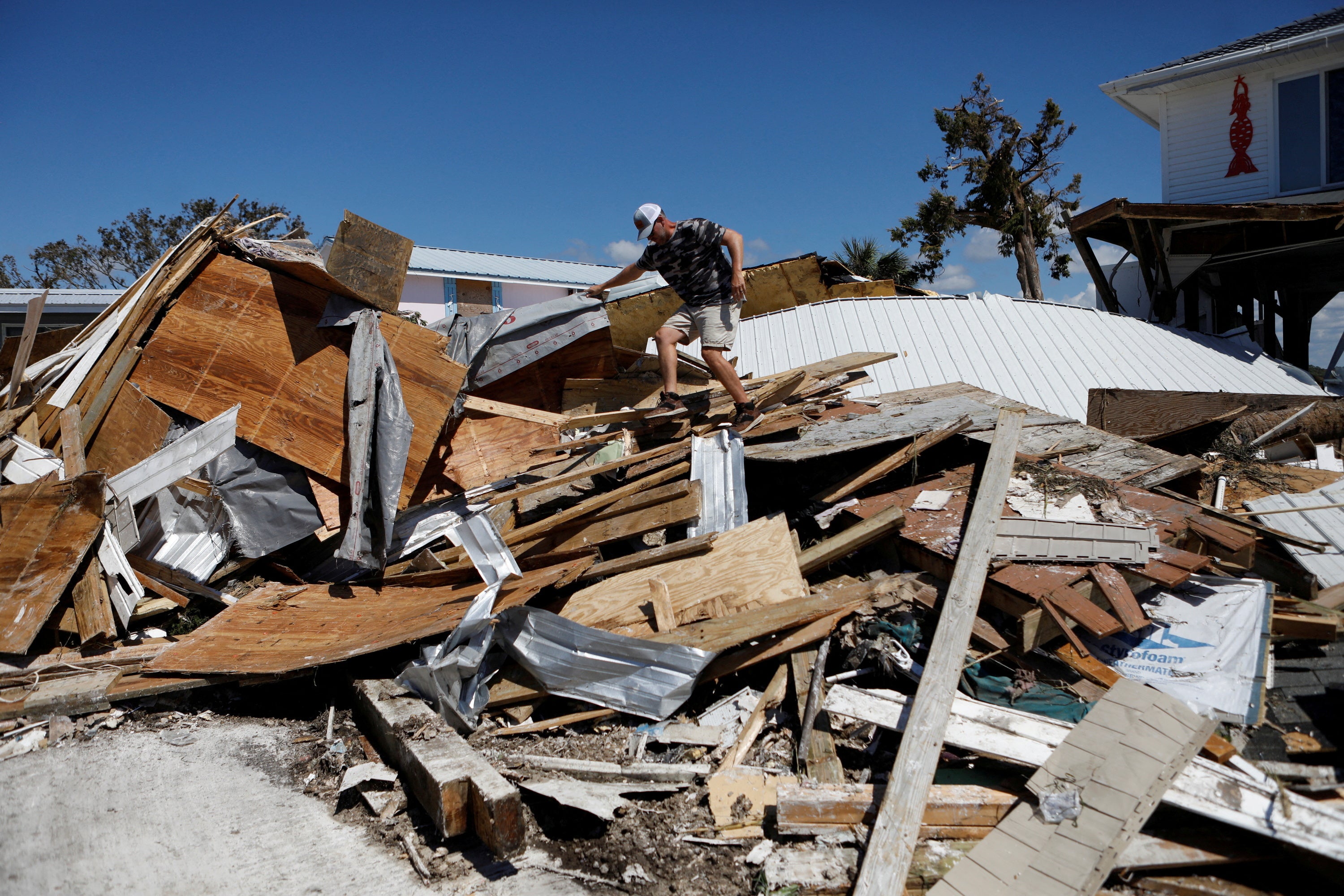 Resident in Keaton Beach tries to recover their belongings on Sunday after Hurricane Helene passed through the Florida panhandle