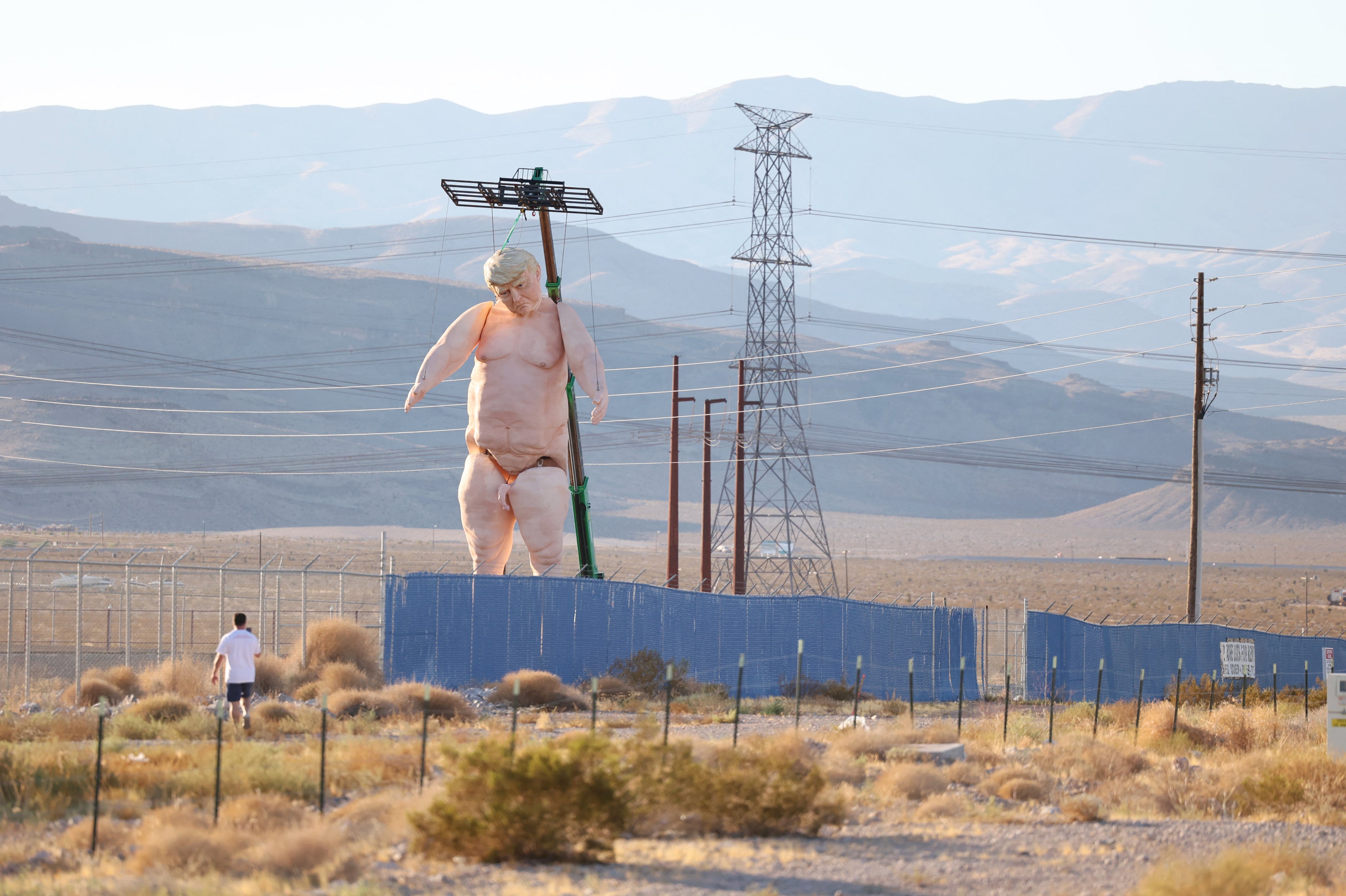 A 43-foot-tall naked statue resembling Donald Trump is displayed in a fenced-in lot near Interstate 15 north of Las Vegas, Nevada, September 28, 2024.