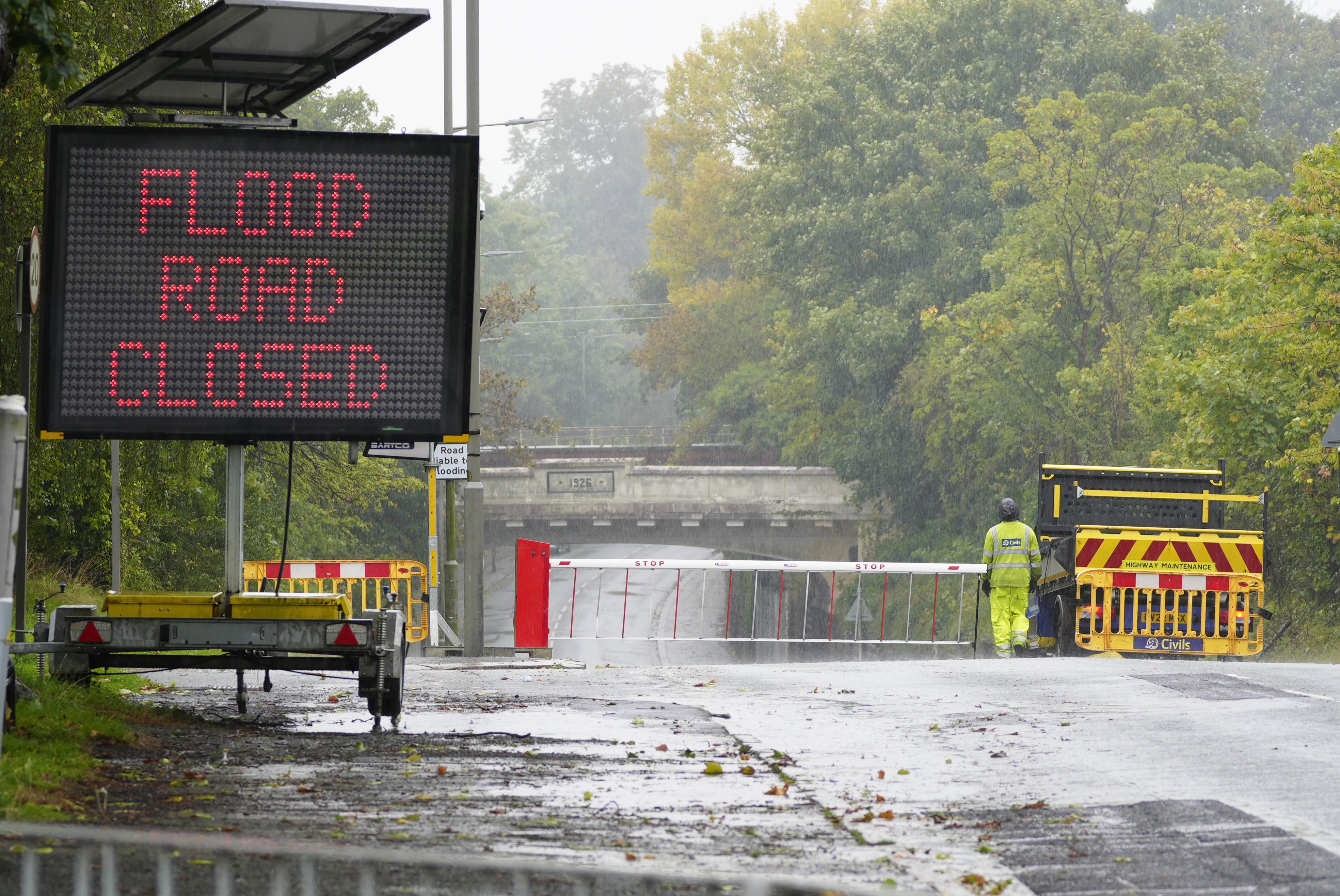 A sign warns of flooding ahead on a road in Liverpool - an area under a Met Office weather warning for rain until 8pm on Monday (Peter Byrne/PA)