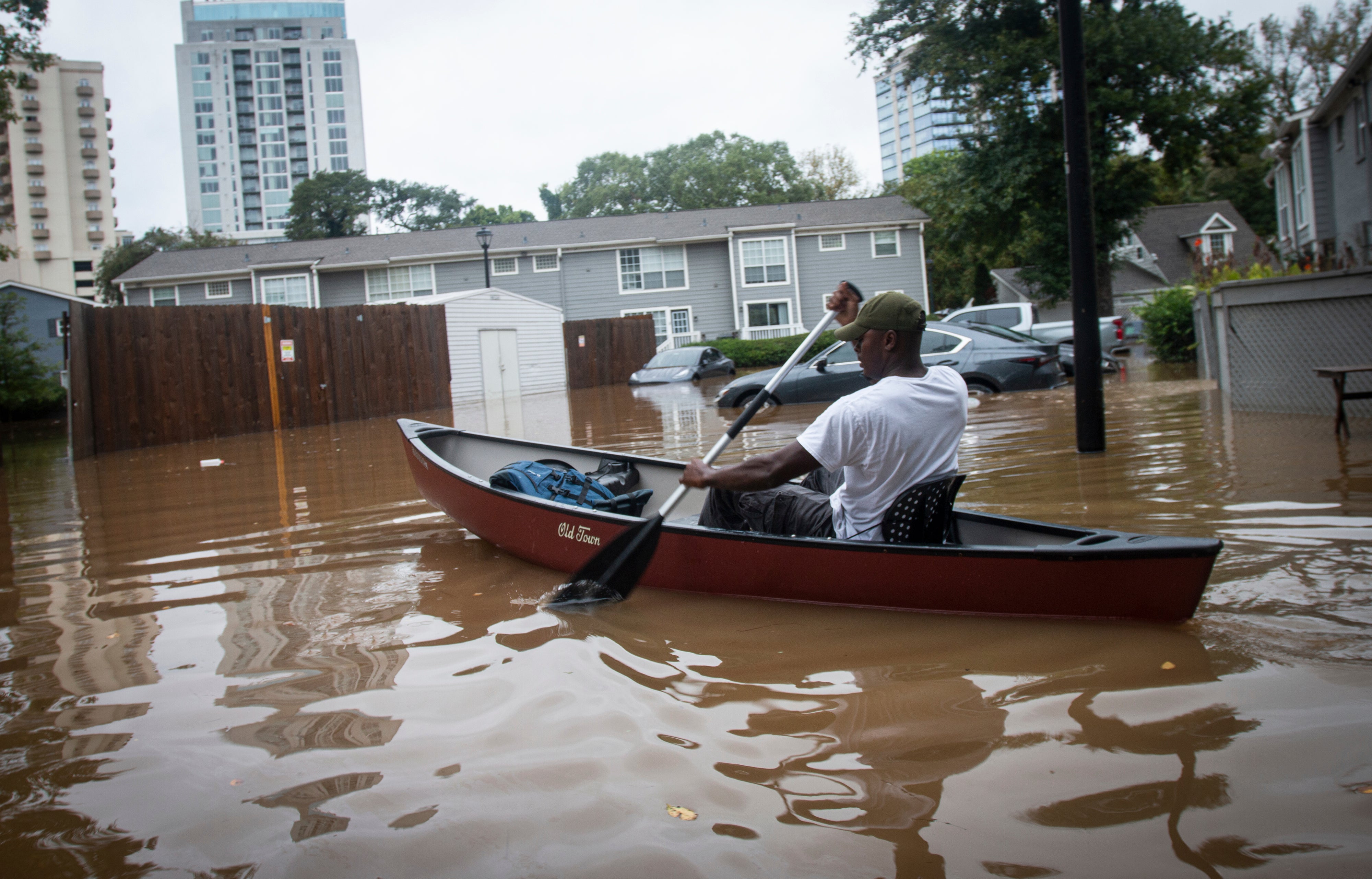 A man paddles a canoe to rescue residents and their belongings at a flooded apartment complex after Hurricane Helene hit Atlanta on Friday