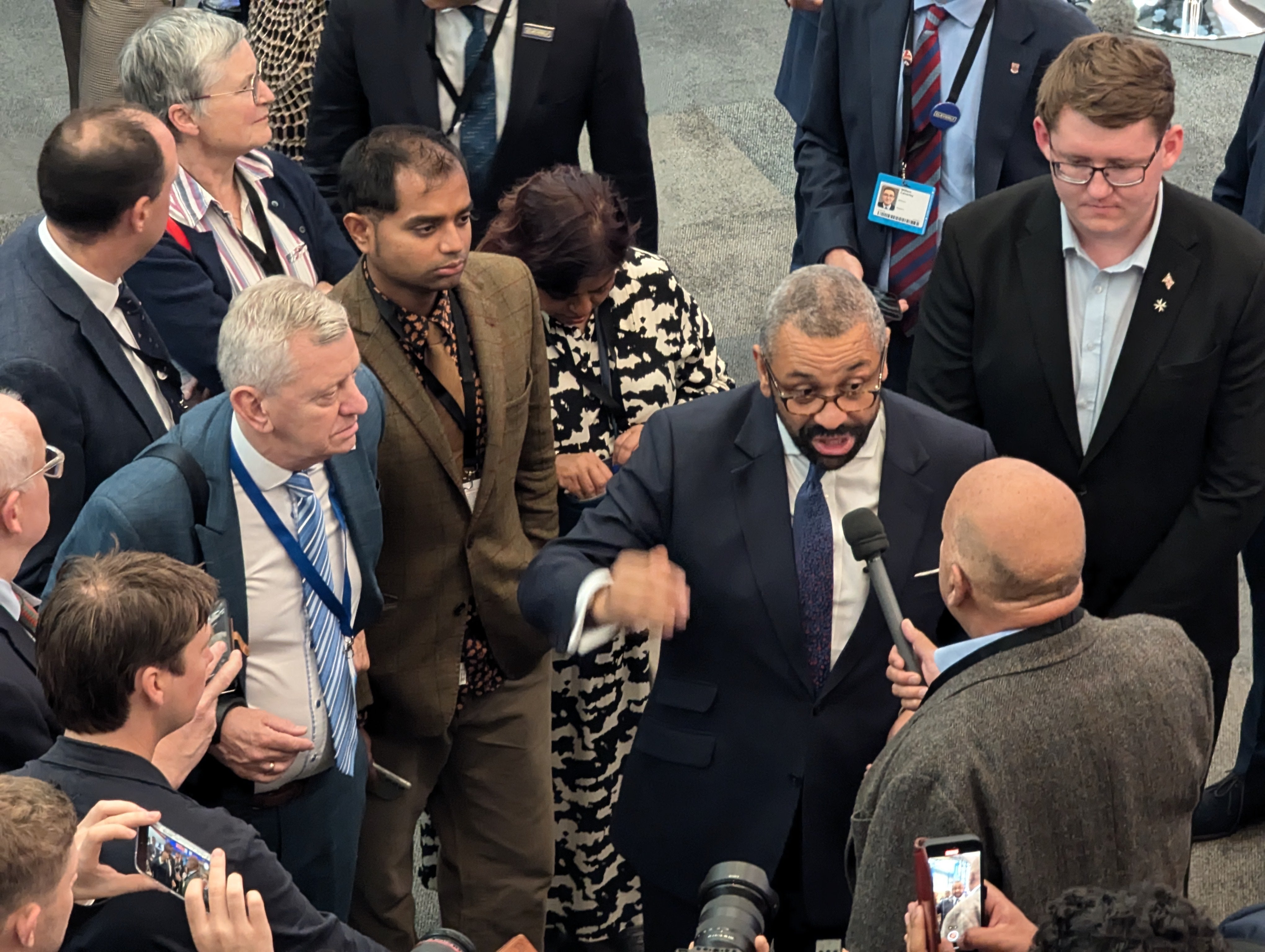 James Cleverly holds court near his stall