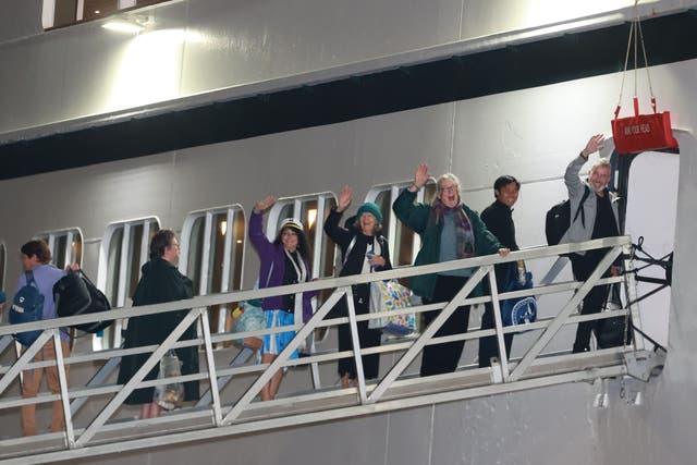 Passengers board the Villa Vie Odyssey cruise ship at Belfast Port’s Cruise Ship Terminal, after the luxury cruise ship became marooned in Belfast for four months due to unexpected repair works. Picture date: Monday September 30, 2024.