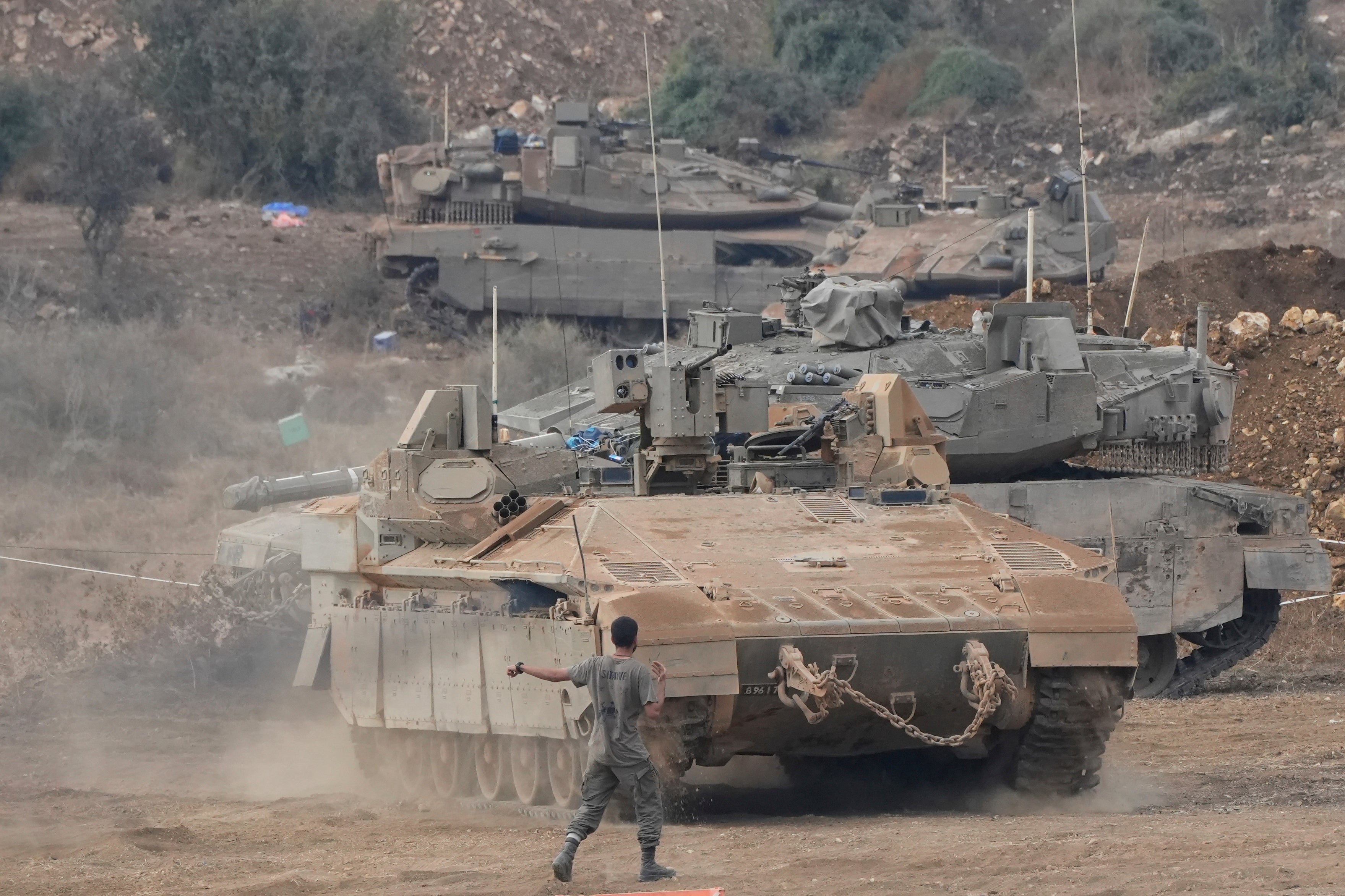 Israeli armored personnel carriers (APC) and tanks maneuver in a staging area in northern Israel near the Israel-Lebanon border, Tuesday, 1 October 2024