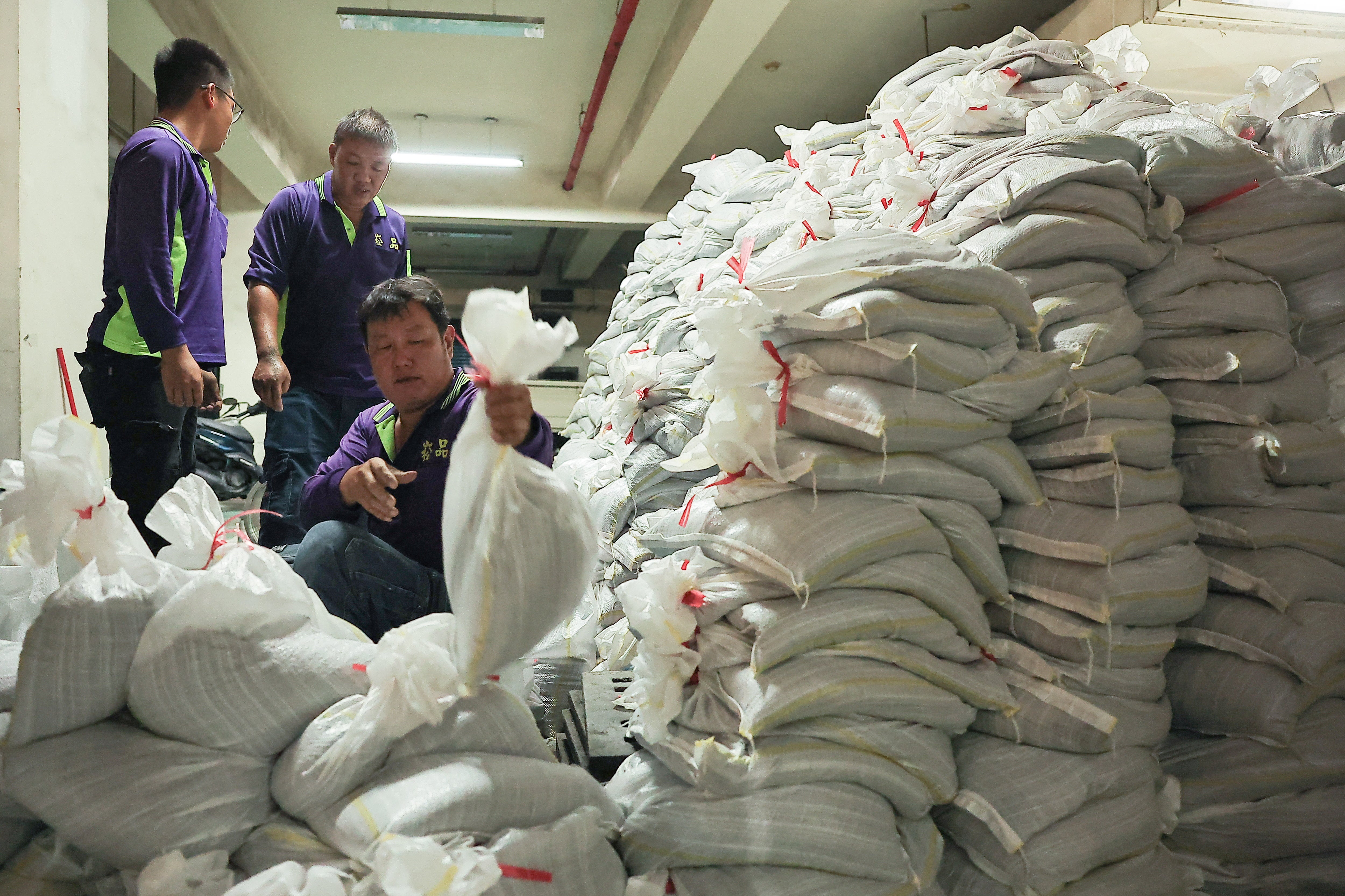 Staff prepare sandbags for Typhoon Krathon in Kaohsiung