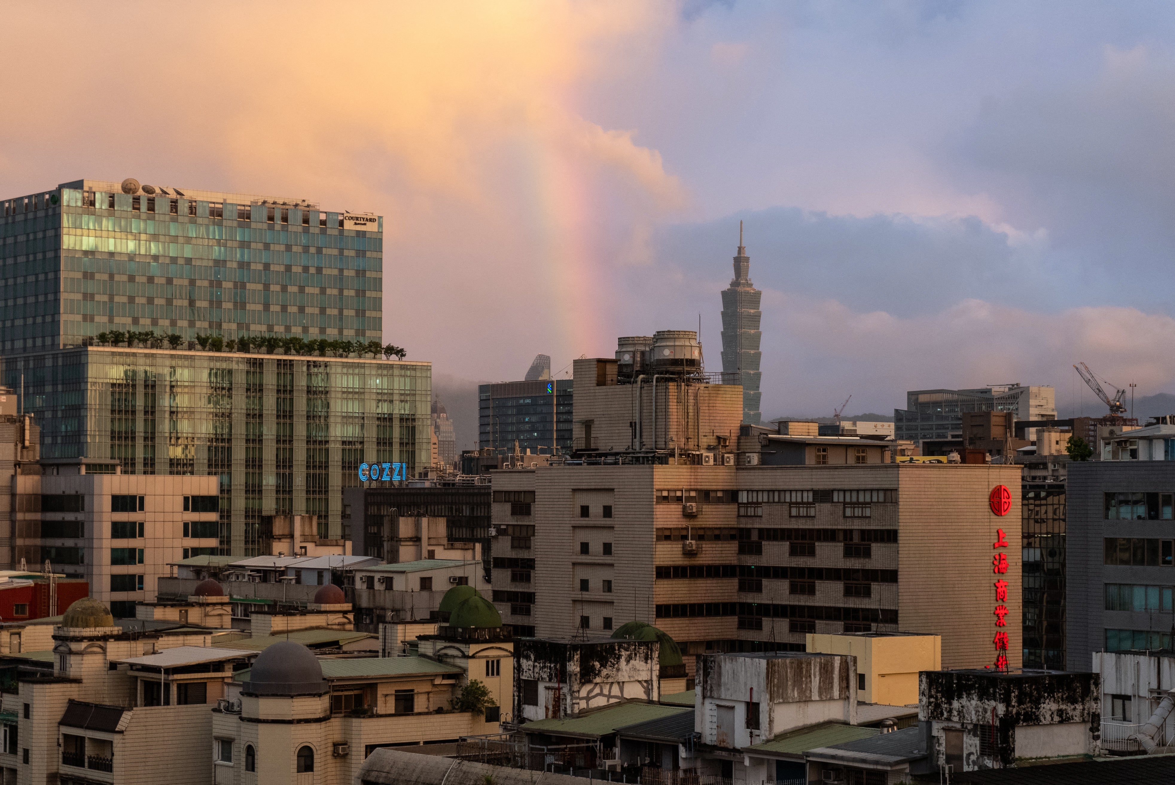 A rainbow can be seen over the city of Taipei at sunset