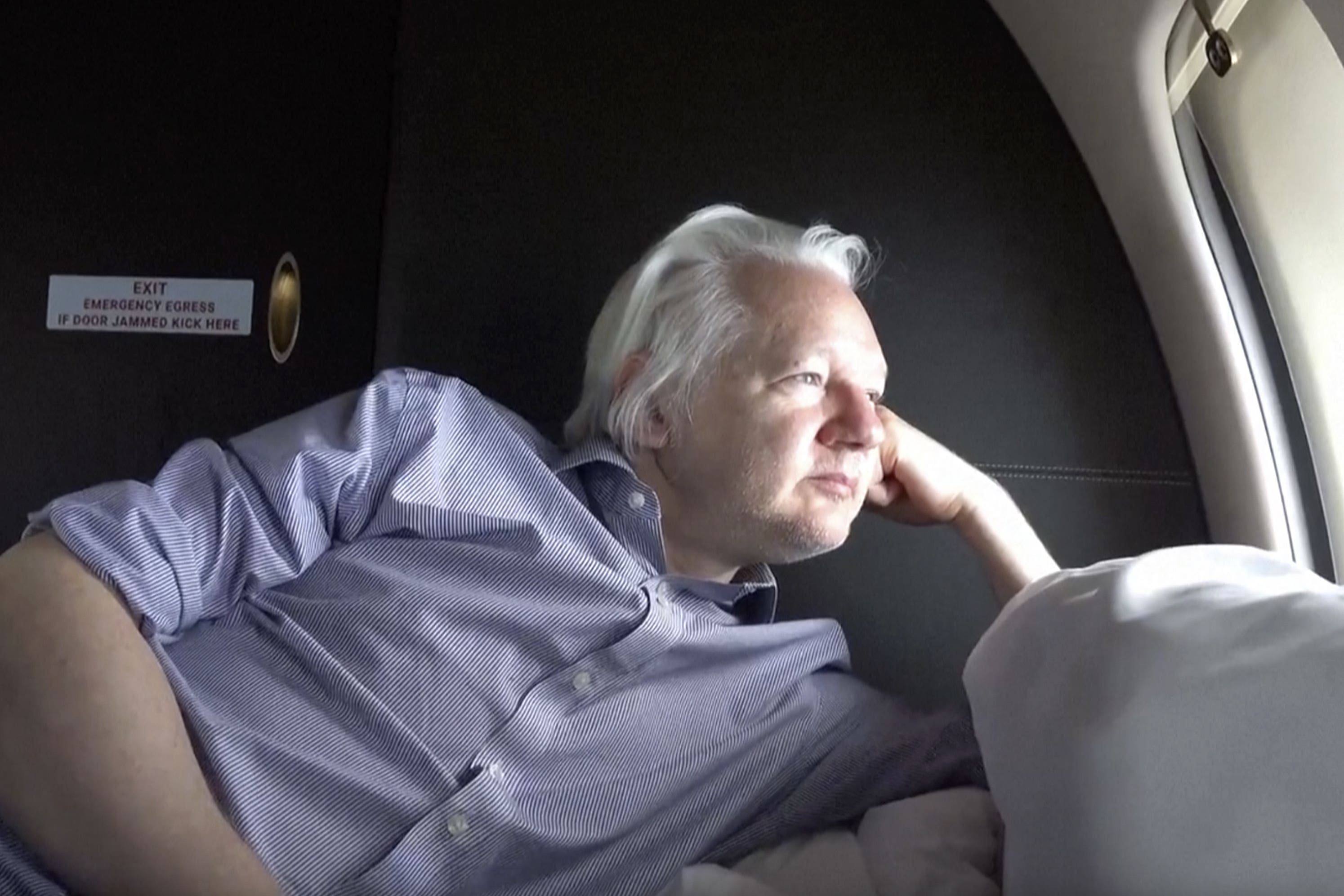 Julian Assange on board a flight to Bangkok, Thailand, following his release from prison (@WikiLeaks/PA)