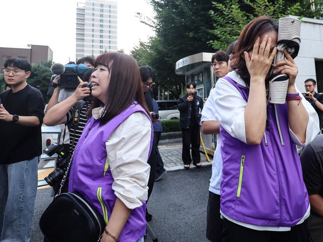 <p>Bereaved family members of the victims outside the court this week </p>