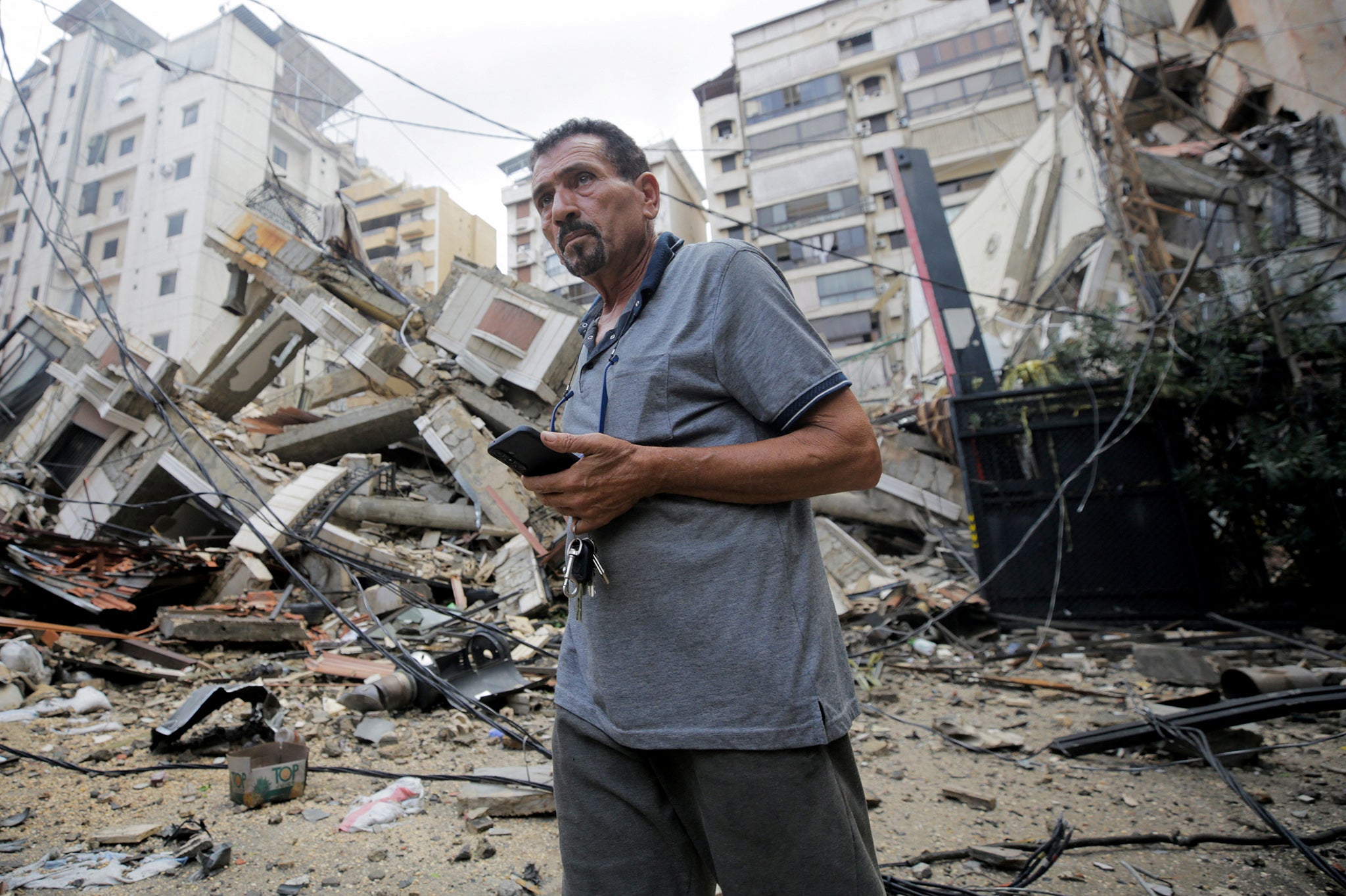 A man stands near damaged buildings, in the aftermath of Israeli strikes on Beirut’s southern suburbs, Lebanon